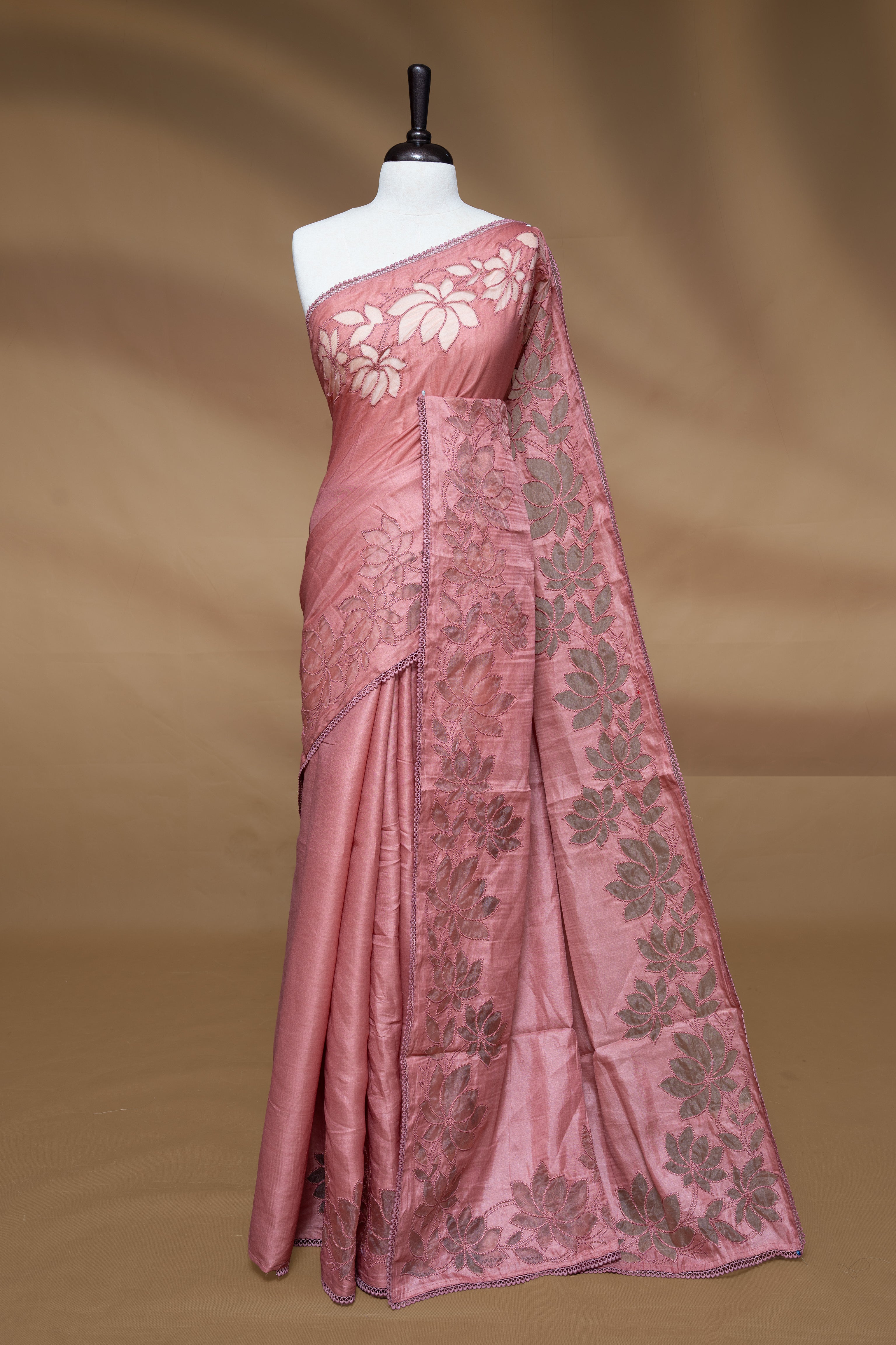 Pastel Peach colour Designer saree Featuring Elegant plain body, enhance with thread Lotus Pattern with lace border, paired with matching blouse piece.