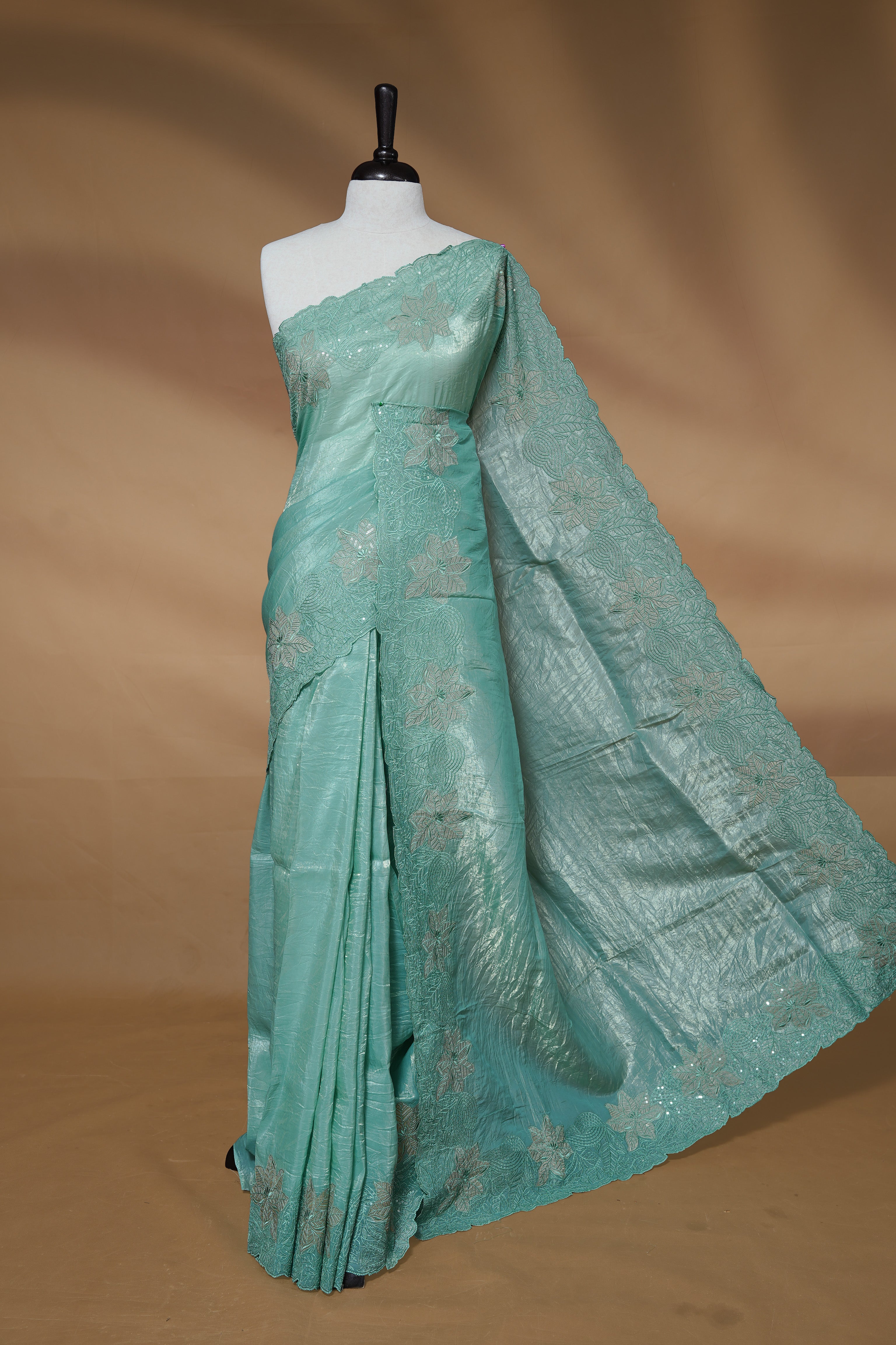 Pastel Green colour Crush Organza Featuring Plain body, Enrich with Floral thread pattern with sequins & scalp border, paired with matching blouse piece.