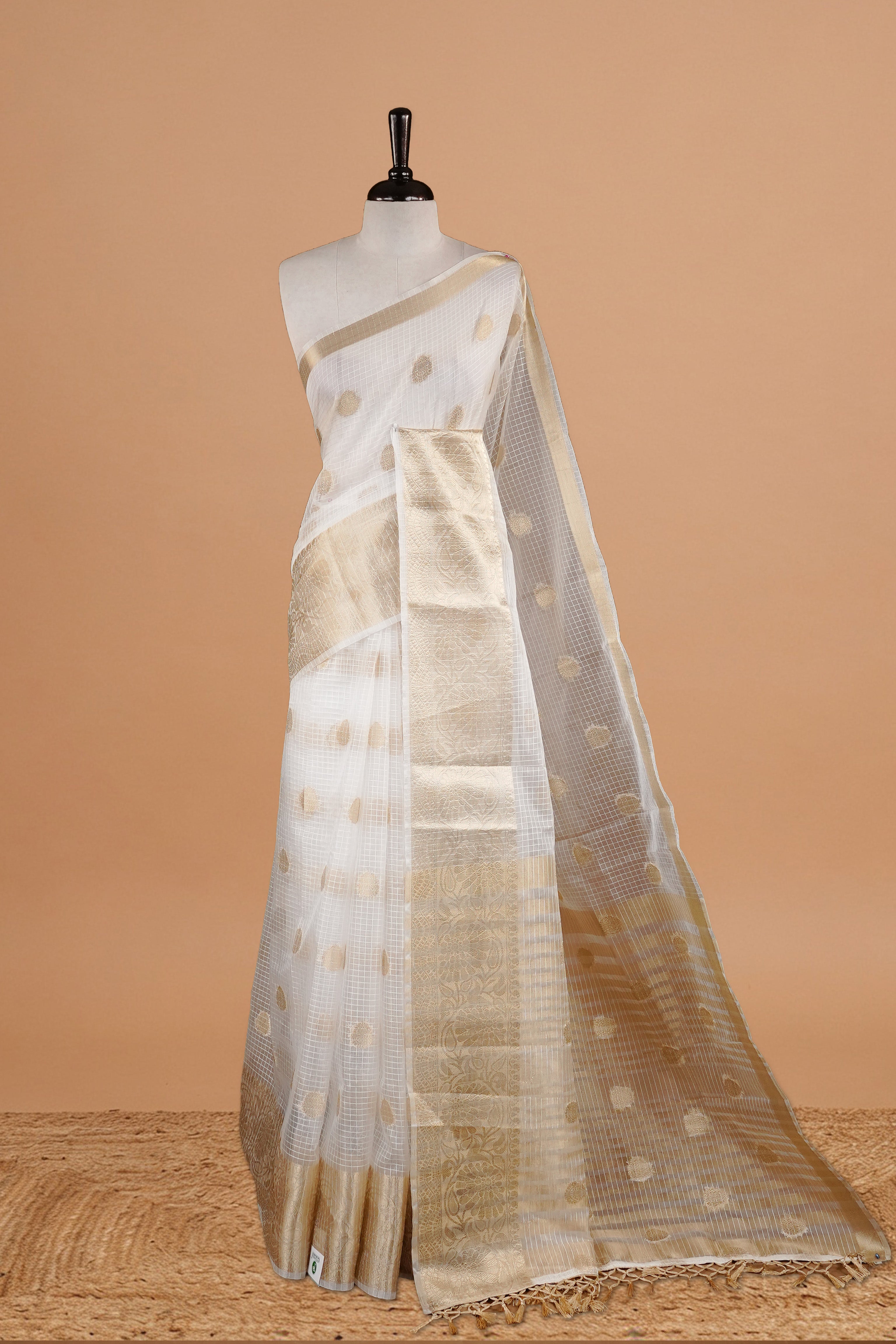 White Colour Semi Organza Saree Featuring Elegant Gold zari Check with motifs on body, Traditional border, comes with matching blouse piece.