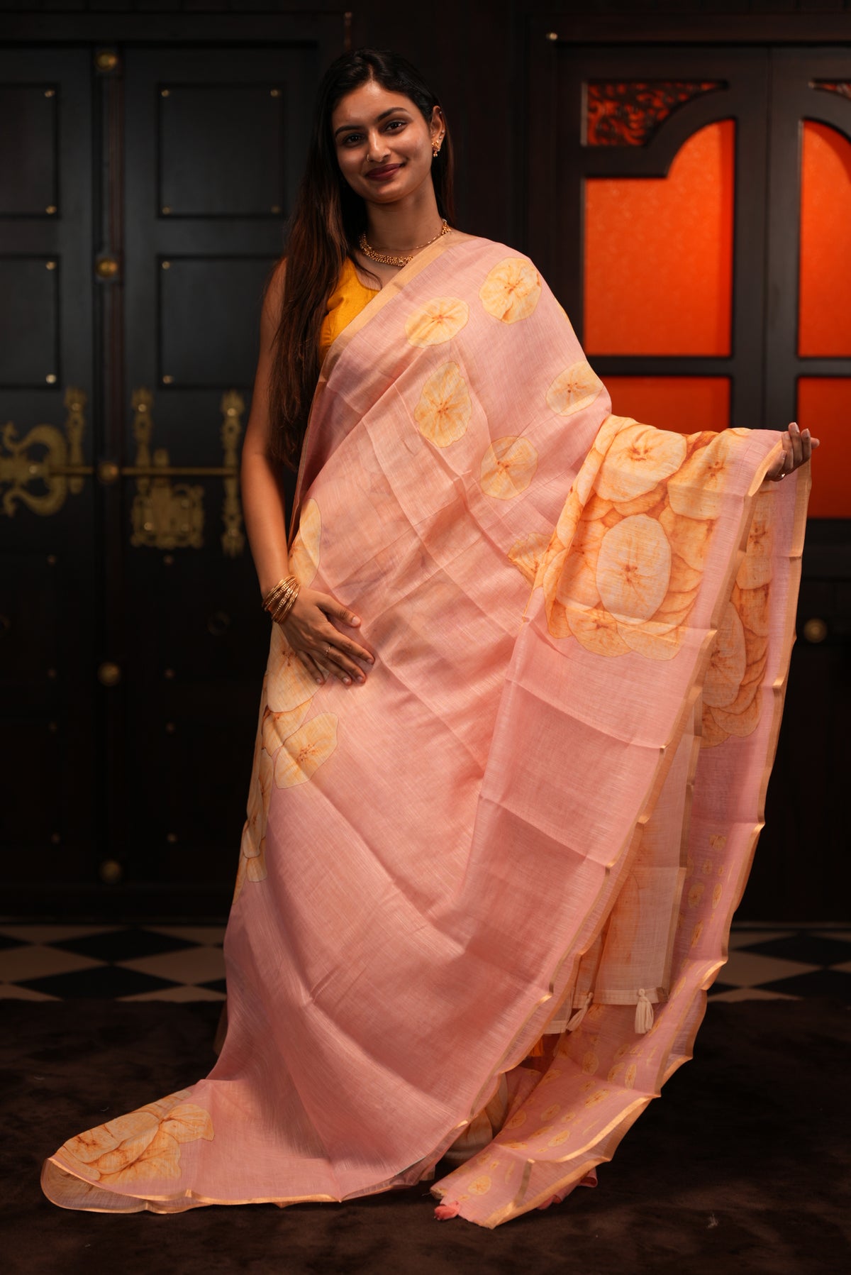 Pink colour Semi Linen saree featuring Banana Chips Print with Gold Tissue Border, comes with tassels.