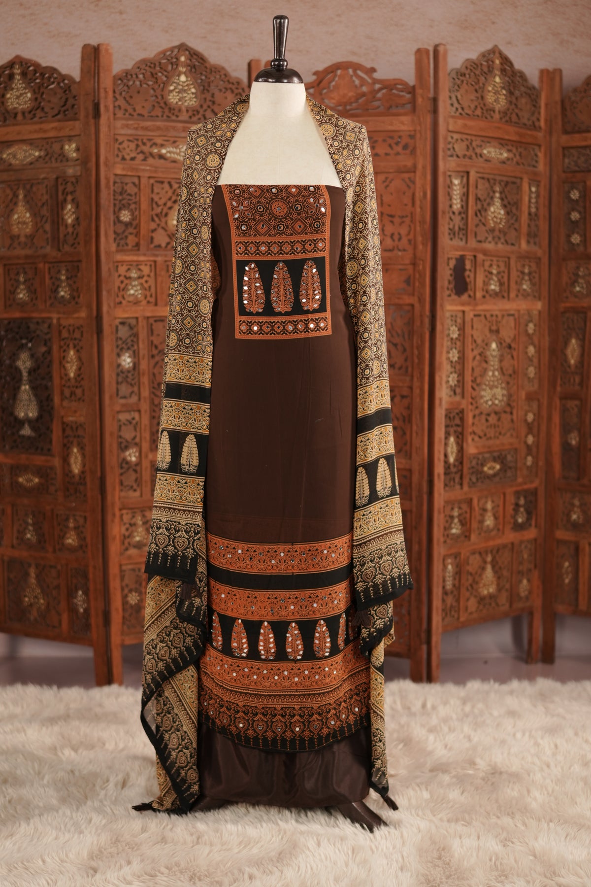 Coffee Brown colour georgette salwar material featuring Daman Print Detailing Mirror work on neck portion, a dupatta with Same print , and Shantoon bottom.