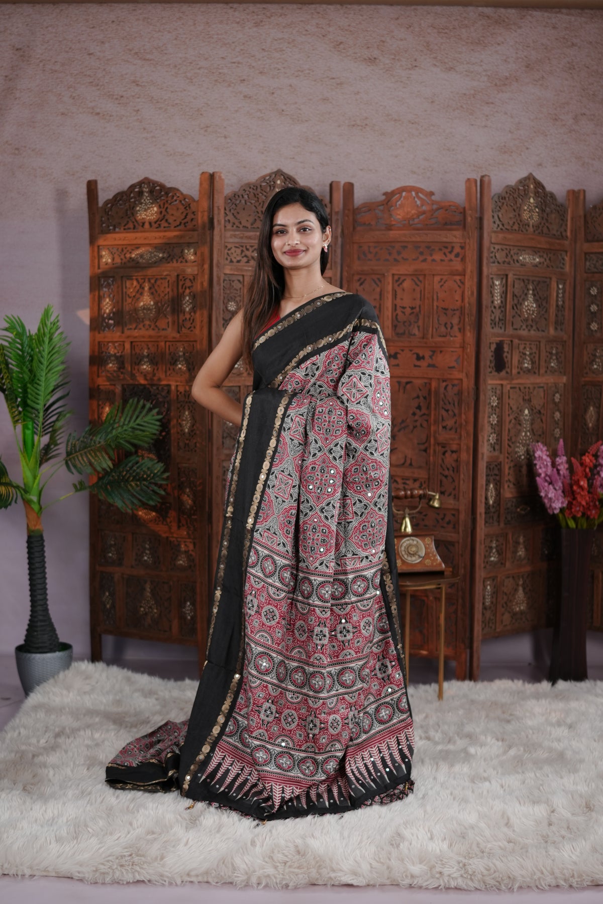 Black Colour Manipuri saree with Ajrakh print with delicate mirror work body, double border, jhumka tassels, matching blouse piece.