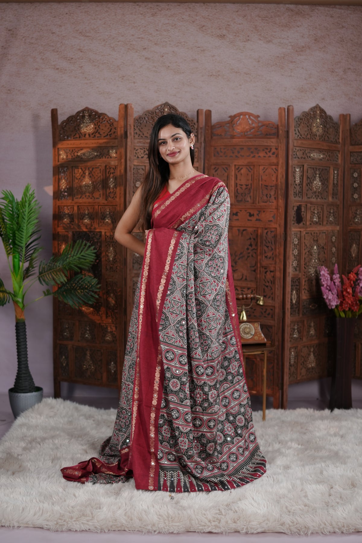 Maroon Colour Manipuri saree with Ajrakh print with delicate mirror work body, double border, jhumka tassels, matching blouse piece.