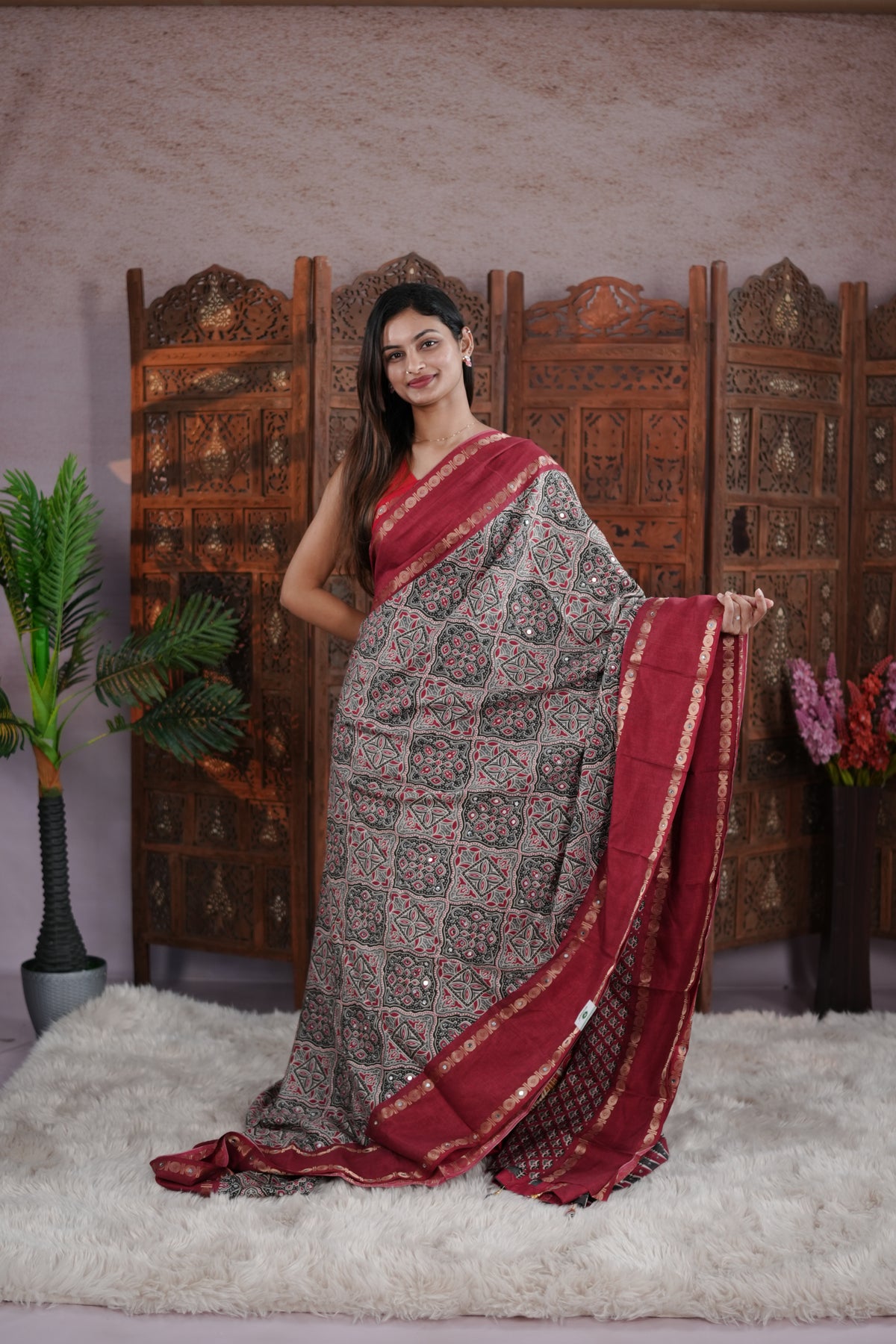 Maroon Colour Manipuri saree with Ajrakh print with delicate mirror work body, double border, jhumka tassels, matching blouse piece.