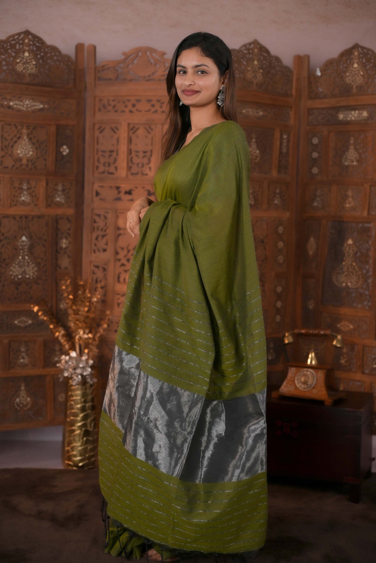 Olive Green Colour Soft Cotton Saree featuring a plain body, complemented by a striped pallu with tissue detailing, paired with a matching blouse piece.