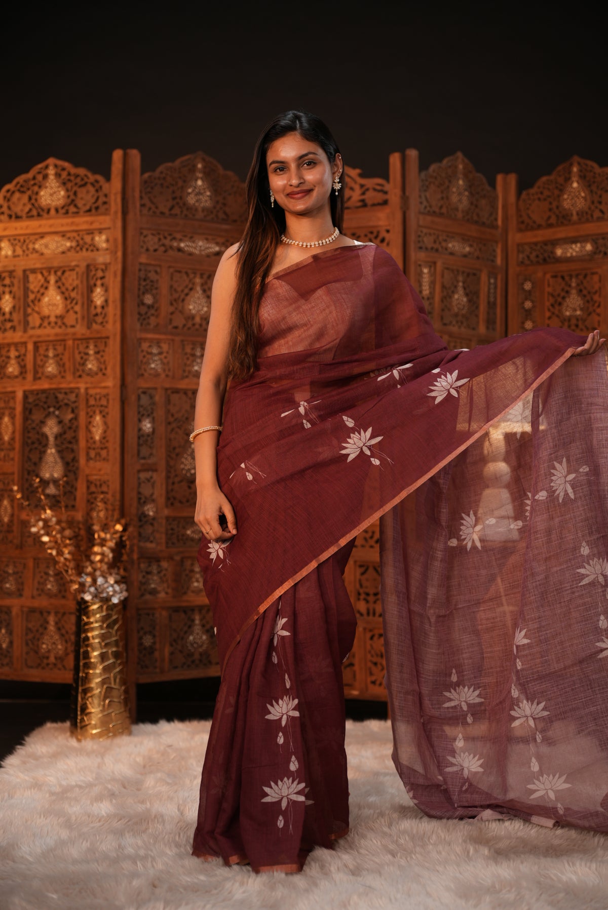 Maroon colour Semi Linen saree featuring plain & lotus print, Bavanchi border & same print on Pallu, comes with contrast colour blouse piece.