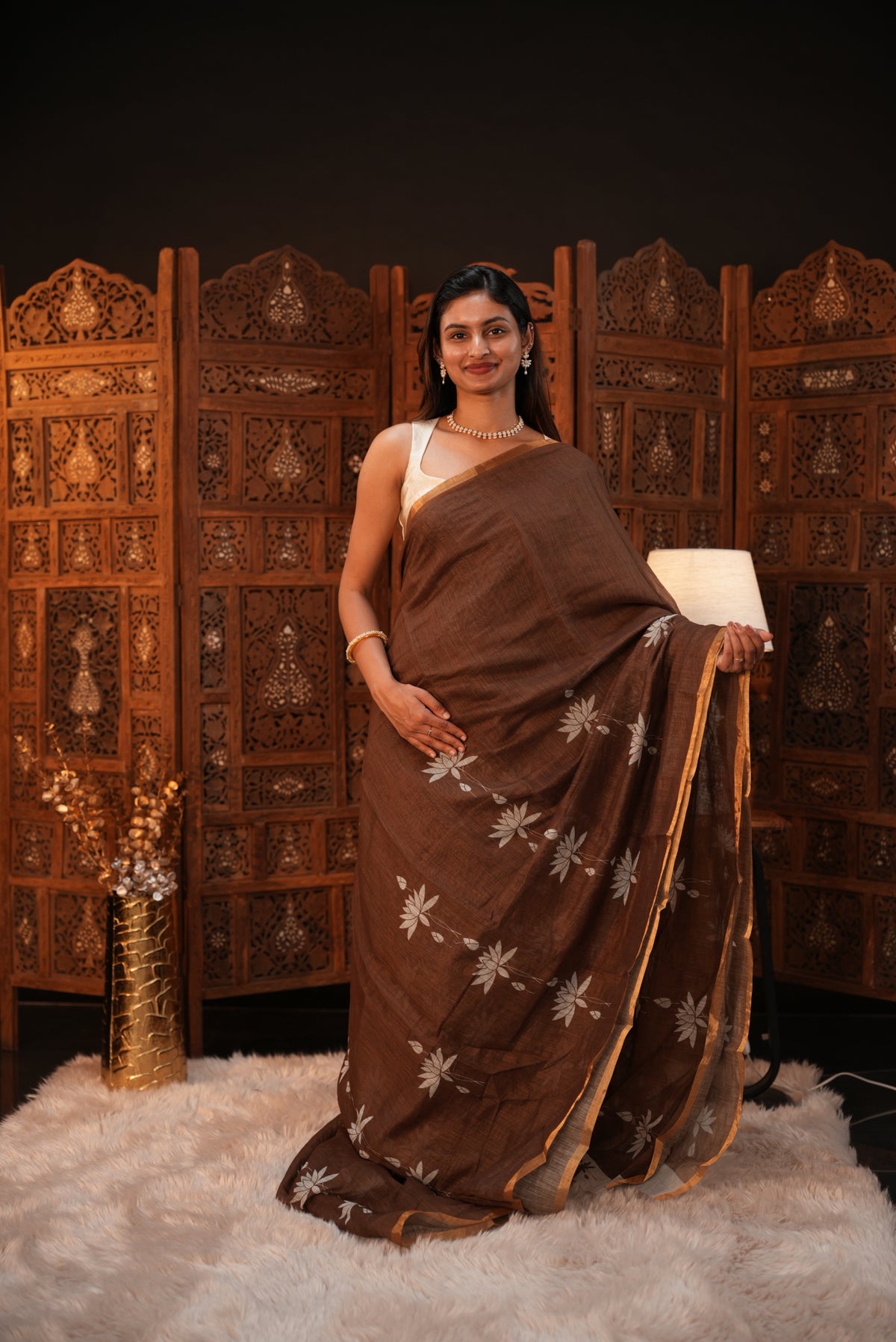 Coffee Brown colour Semi Linen saree featuring plain & lotus print, Bavanchi border & same print on Pallu, comes with contrast colour blouse piece.