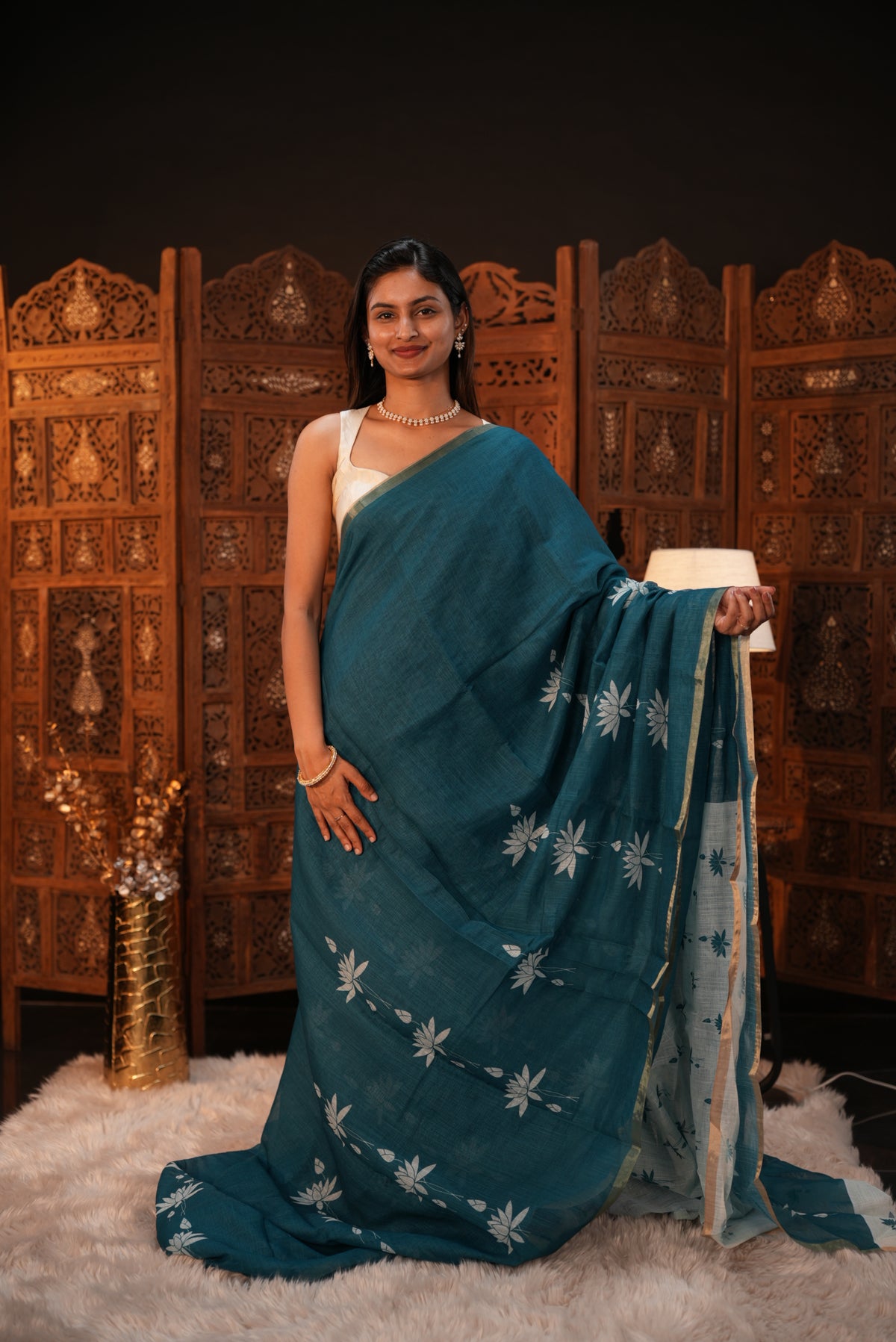 Peacock Green colour Semi Linen saree featuring plain & lotus print, Bavanchi border & same print on Pallu, comes with contrast colour blouse piece.
