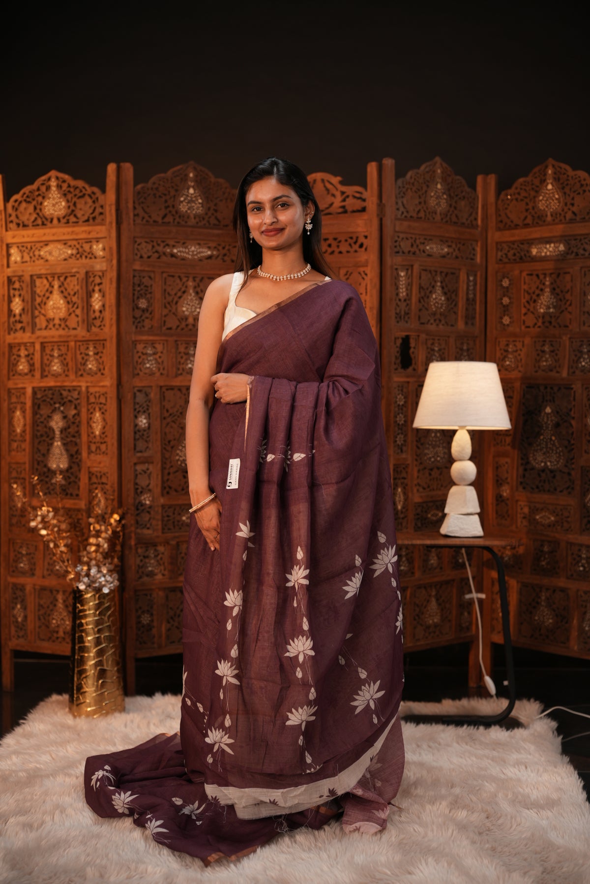 Wine colour Semi Linen saree featuring plain & lotus print, Bavanchi border & same print on Pallu, comes with contrast colour blouse piece.
