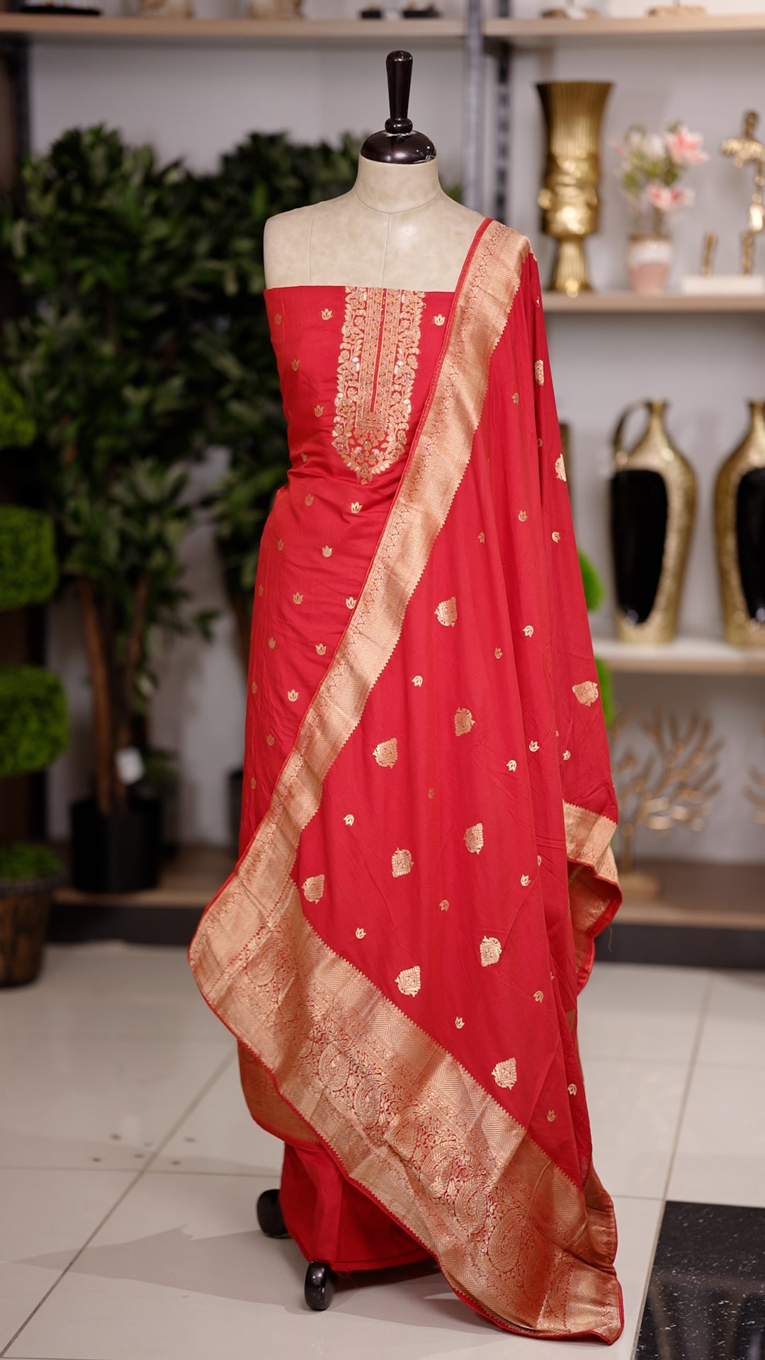 Red colour semi silk salwar suit featuring heavy golden embroidery thread work on the top, paired with a plain bottom & Comes with a dupatta highlighted with golden work along the side border.