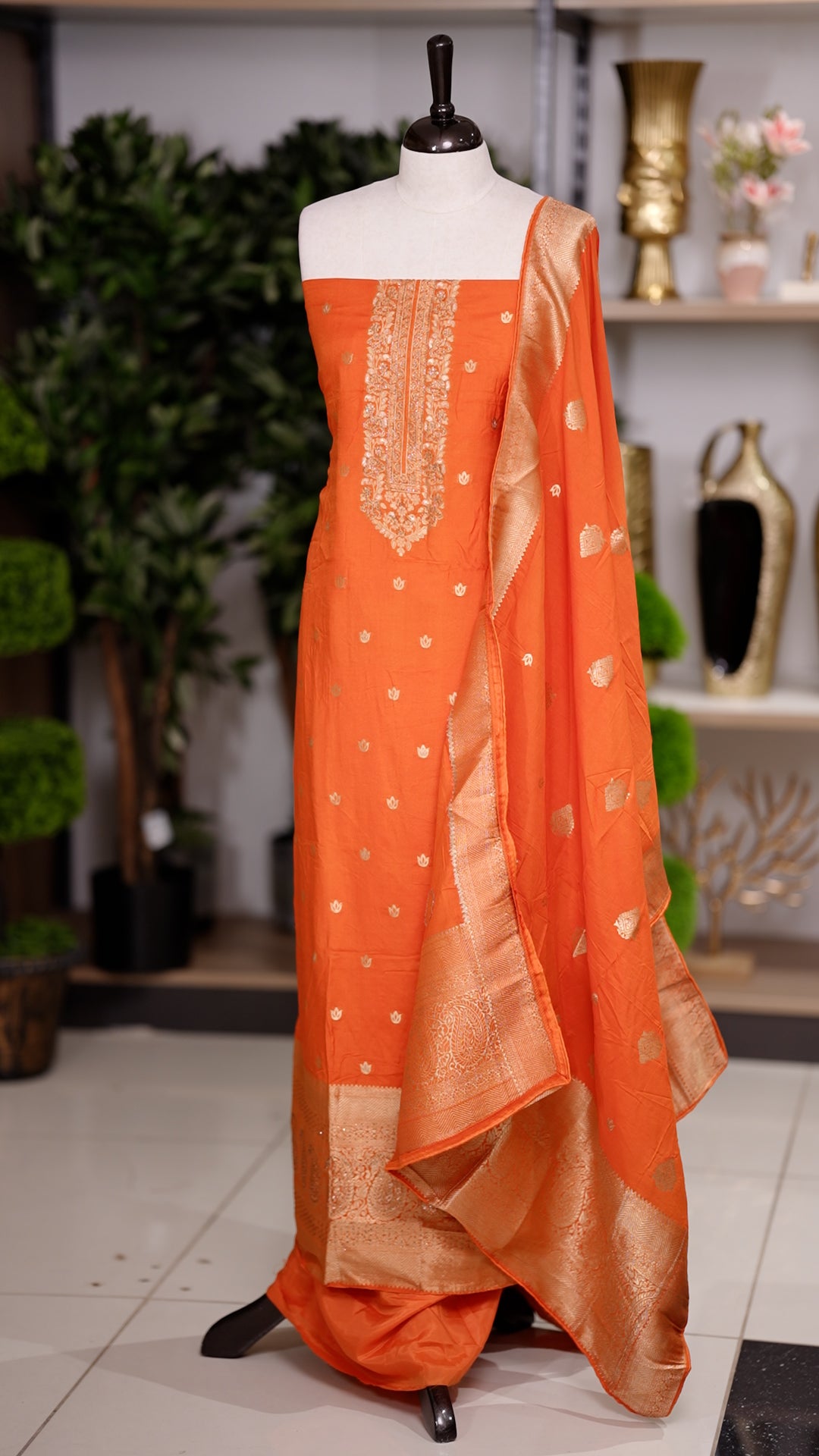 Orange colour semi silk salwar suit featuring heavy golden embroidery thread work on the top, paired with a plain bottom & Comes with a dupatta highlighted with golden work along the side border.