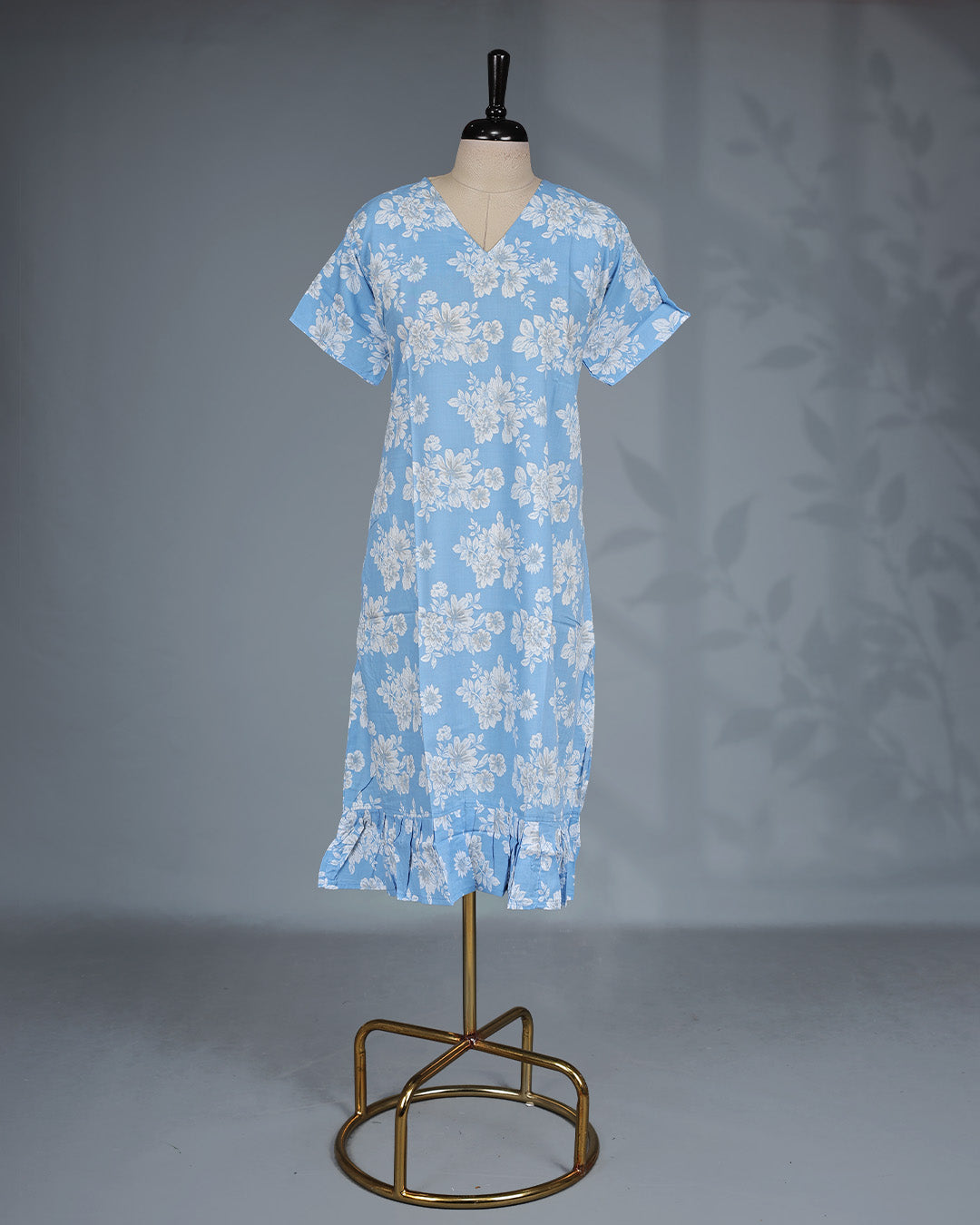 Sky Blue colour nighty featuring white floral prints on body , a V-neckline, short sleeves, and a ruffled mid-length fit.