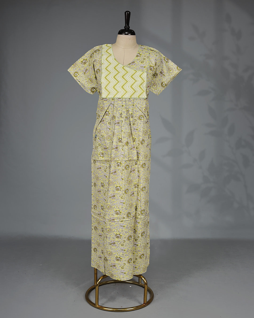 Lemon yellow floral kodi printed nighty with a stylish contrast asymmetrical zigzag yoke, V-neckline, butterfly sleeves and a relaxed full-length silhouette for breathable comfort and elegant everyday wear.