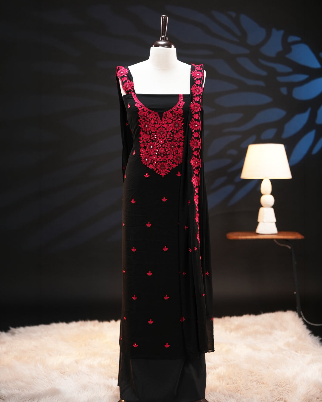 Black colour georgette salwar material featuring elegant threadwork on the body and intricate threadwork with sequin detailing on neckline, paired with a scalloped border dupatta and Shantoon bottom