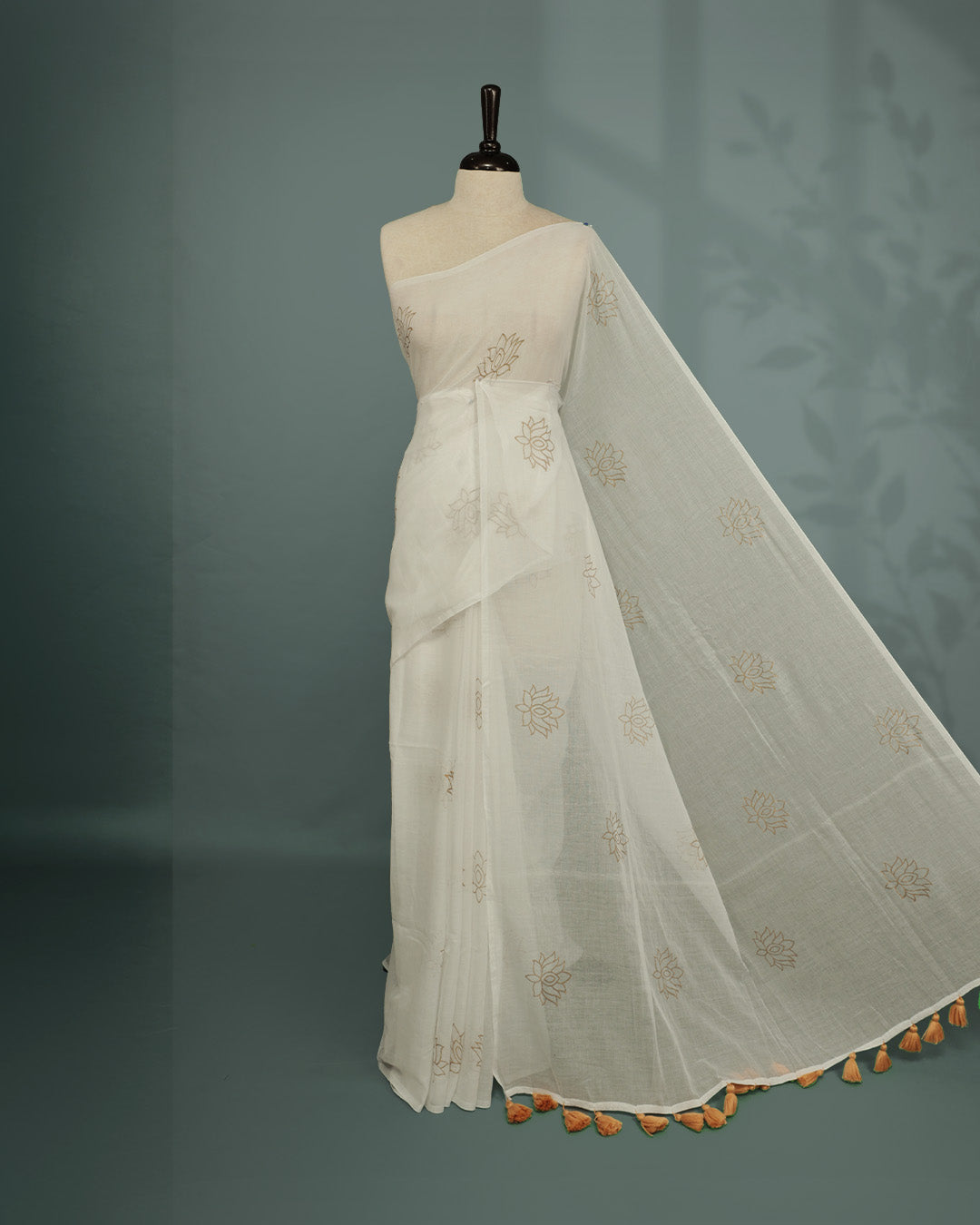 White colour pure mul cotton saree featuring Minimal Lotus Print on body, Clean Borderless design, elegant tassels.