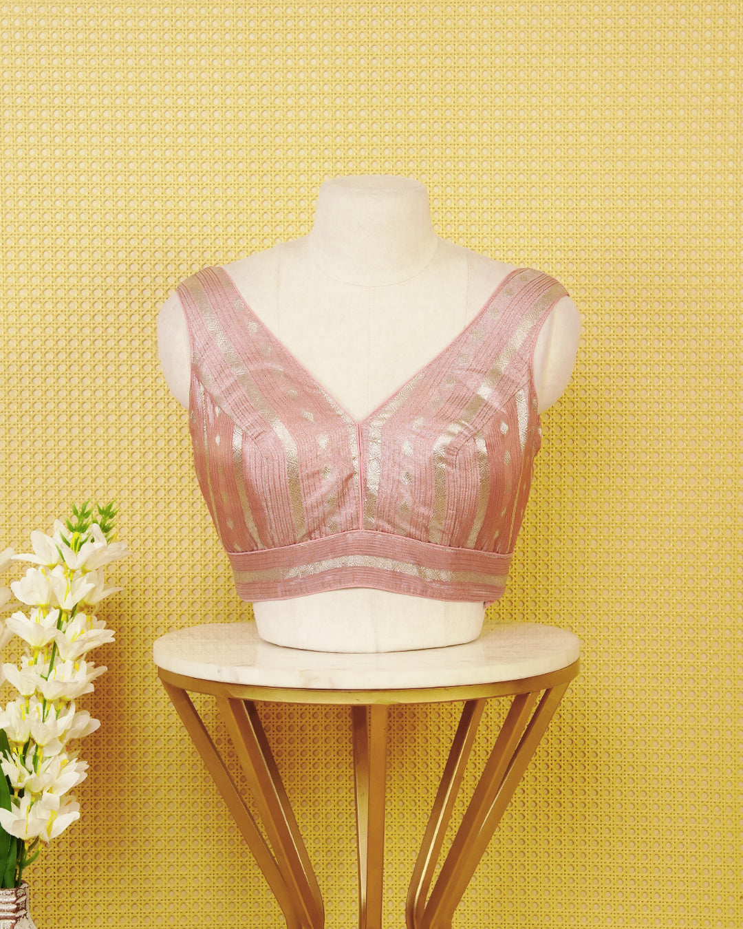 Baby pink colour Sleeveless Blouse Featuring A Stylish V-Neck, Elegant Woven Zari Stripes With Butta Motifs, And A Comfortable Tailored Fit.