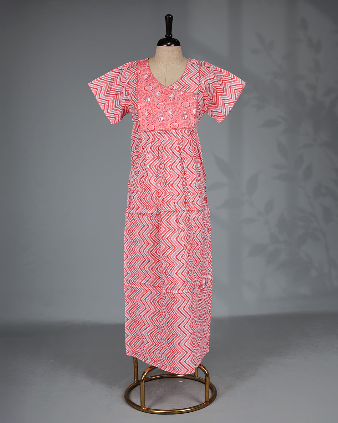 Light Red colour printed nighty with a stylish contrast asymmetrical yoke, V-neckline, short sleeves and a relaxed full-length silhouette for comfortable everyday wear with a modern touch.