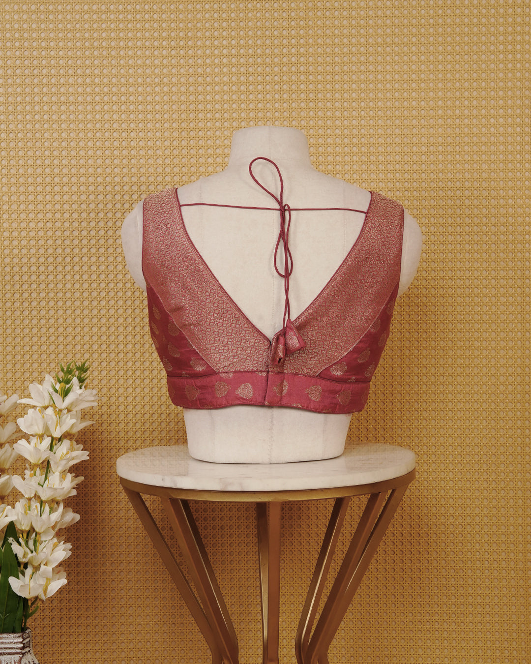 Mauve colour Sleeveless Blouse Featuring A Stylish V-Neck, Elegant Woven Pattern With Gold Butta Motifs, And A Comfortable Tailored Fit.