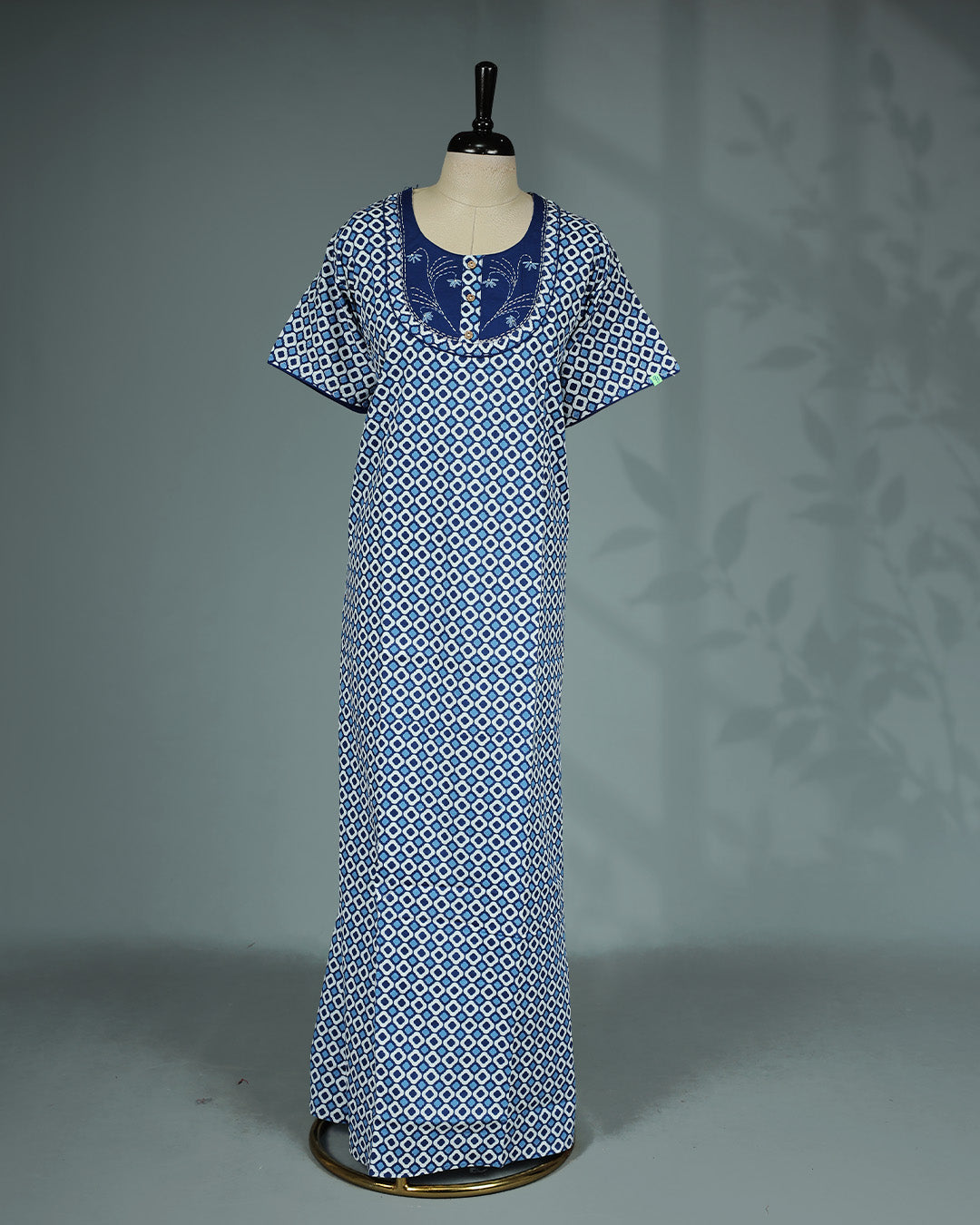 Blue and white geometric printed nighty with a classic soft square neckline, short sleeves, an embroidered contrast yoke with wooden button detailing, and a relaxed full-length for everyday comfort and timeless style.