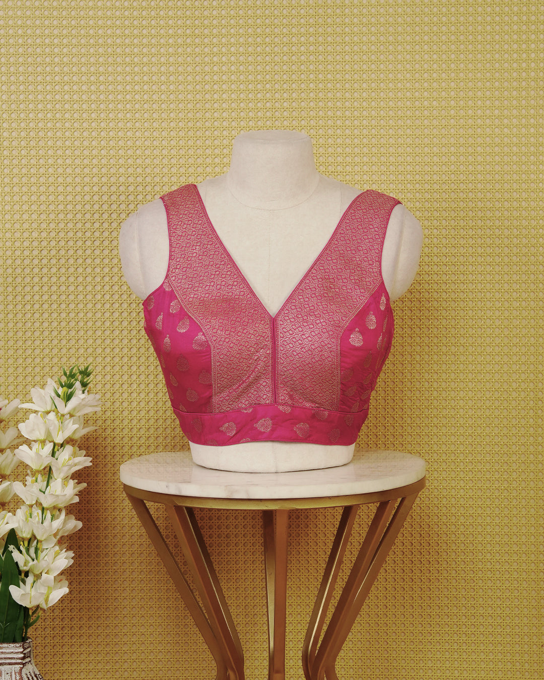 Pink colour Sleeveless Blouse Featuring A Stylish V-Neck, Elegant Woven Pattern With Gold Butta Motifs, And A Comfortable Tailored Fit.