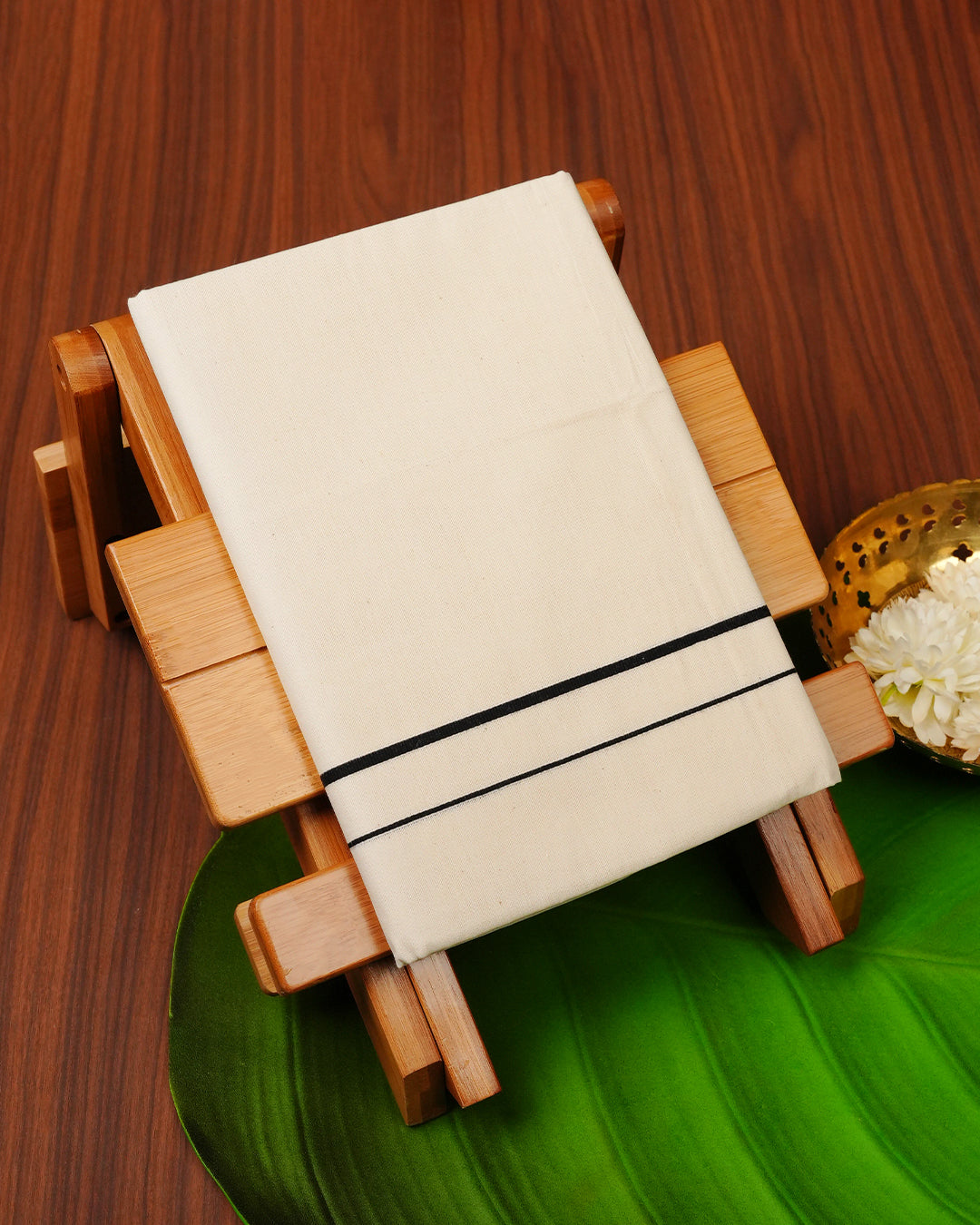 Cream colour cotton single dhoti featuring Black colour simple border.