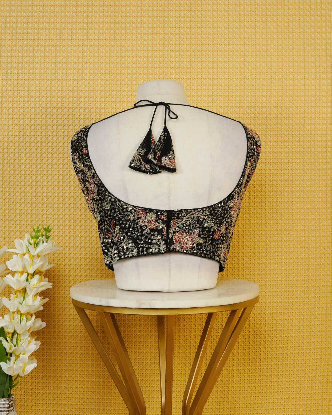 Black colour Embroidered Sleeveless Blouse Featuring A Stylish V-Neck, Intricate Floral Embroidery With Sequin Detailing, And A Comfortable Tailored Fit.