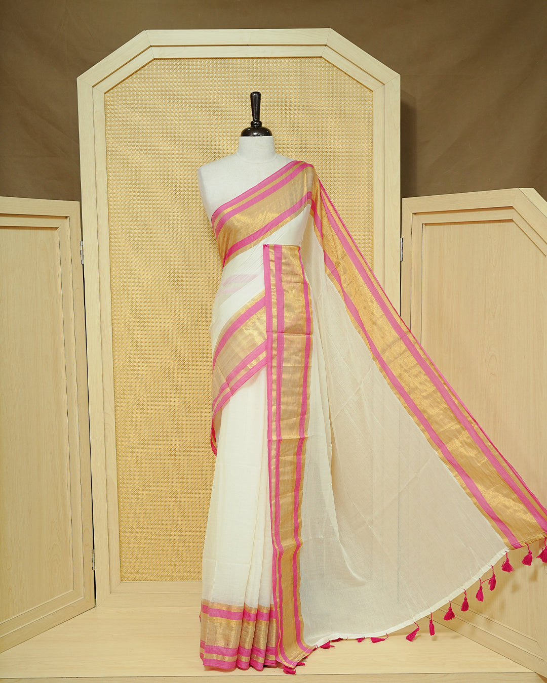 Off White Mul Cotton Saree featuring a gold zari border with pink stripes, A Matching Pallu & finished with pink tassels