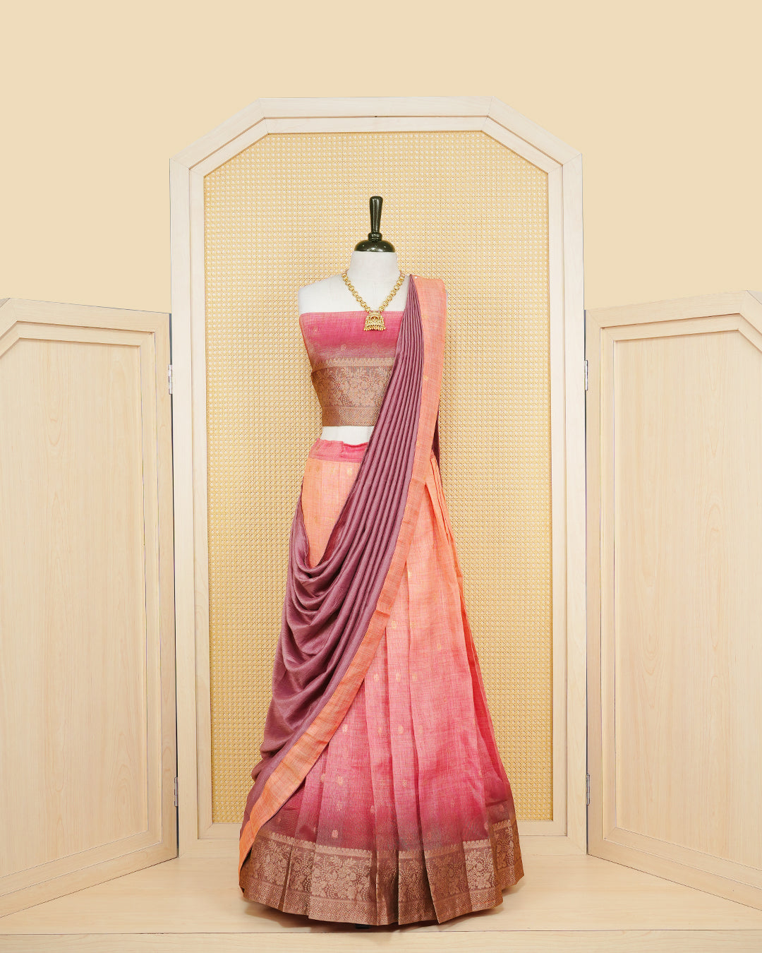 Peach & dusty maroon colour Linen Silk Semi stitched dhavani set featuring buttas, zari bordered skirt & blouse piece and dupatta.