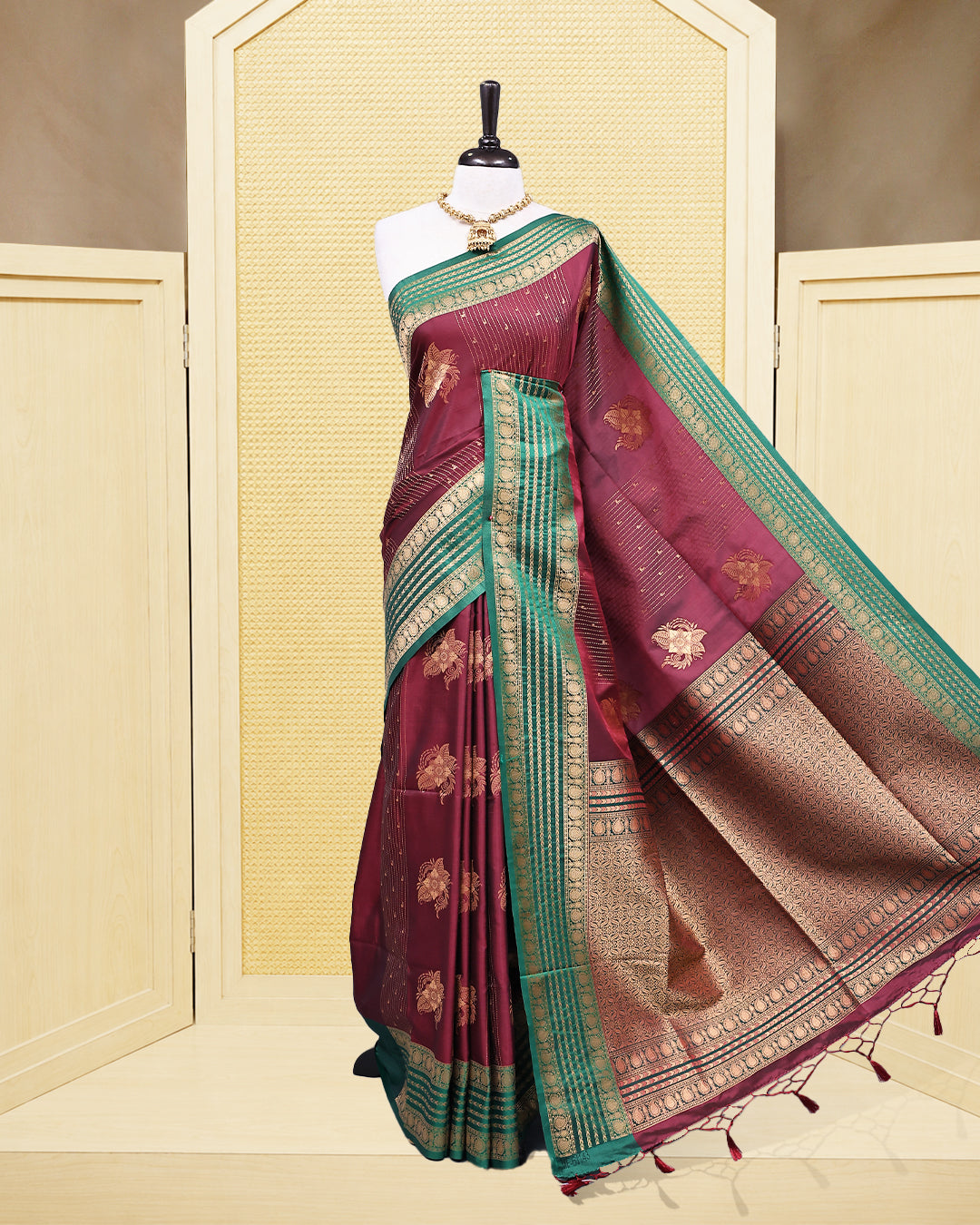Maroon & gold double shade Mulberry silk saree featuring floral gold zari patterns on body, paired with contrast green colour with traditional border, comes with matching blouse piece.