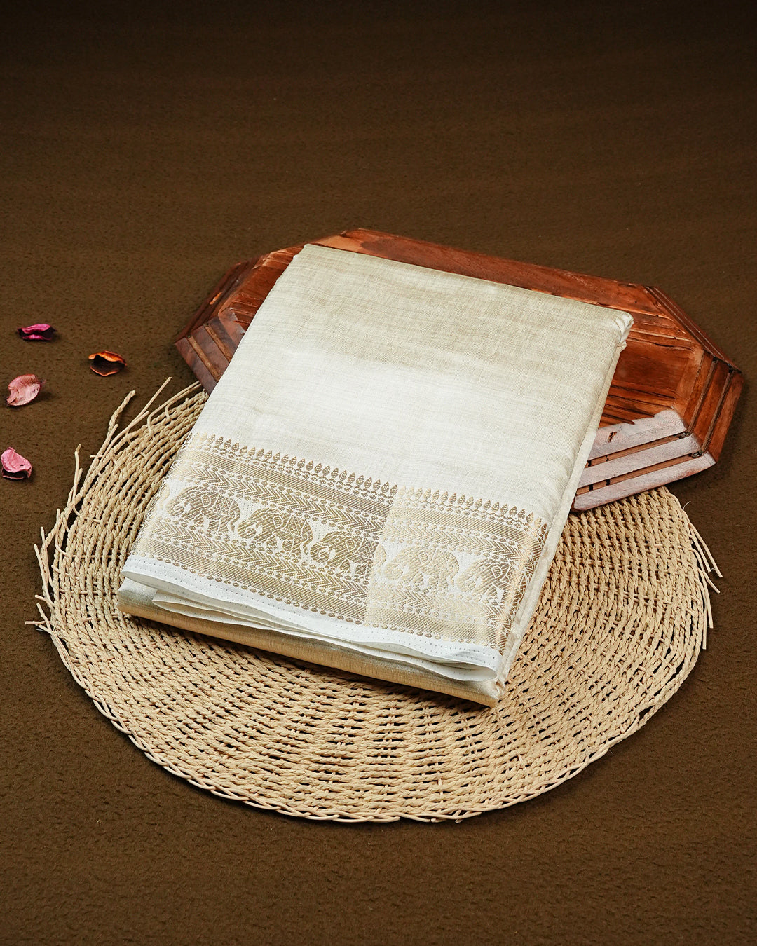 Off white gold Tussar saree featuring Gold zari buttas on body, complemented by self colour with traditional border, comes with matching blouse piece.
