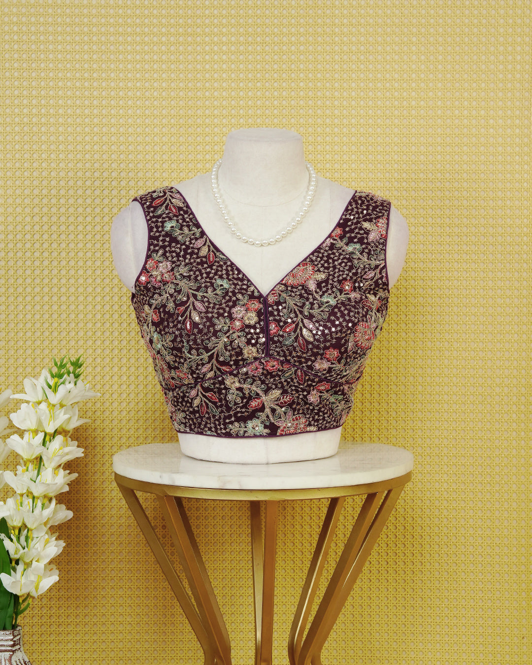Purple colour Embroidered Sleeveless Blouse Featuring A Stylish V-Neck, Intricate Floral Embroidery With Sequin Detailing, And A Comfortable Tailored Fit.