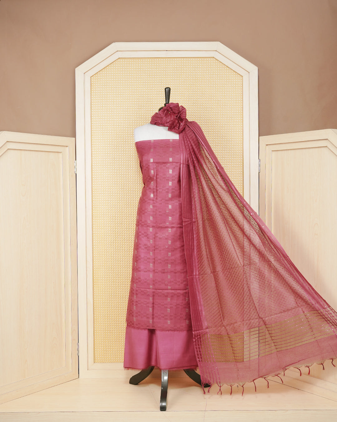 Maroon colour silk cotton salwar material featuring gold zari design without border, paired with matching bottom and beautiful dupatta.