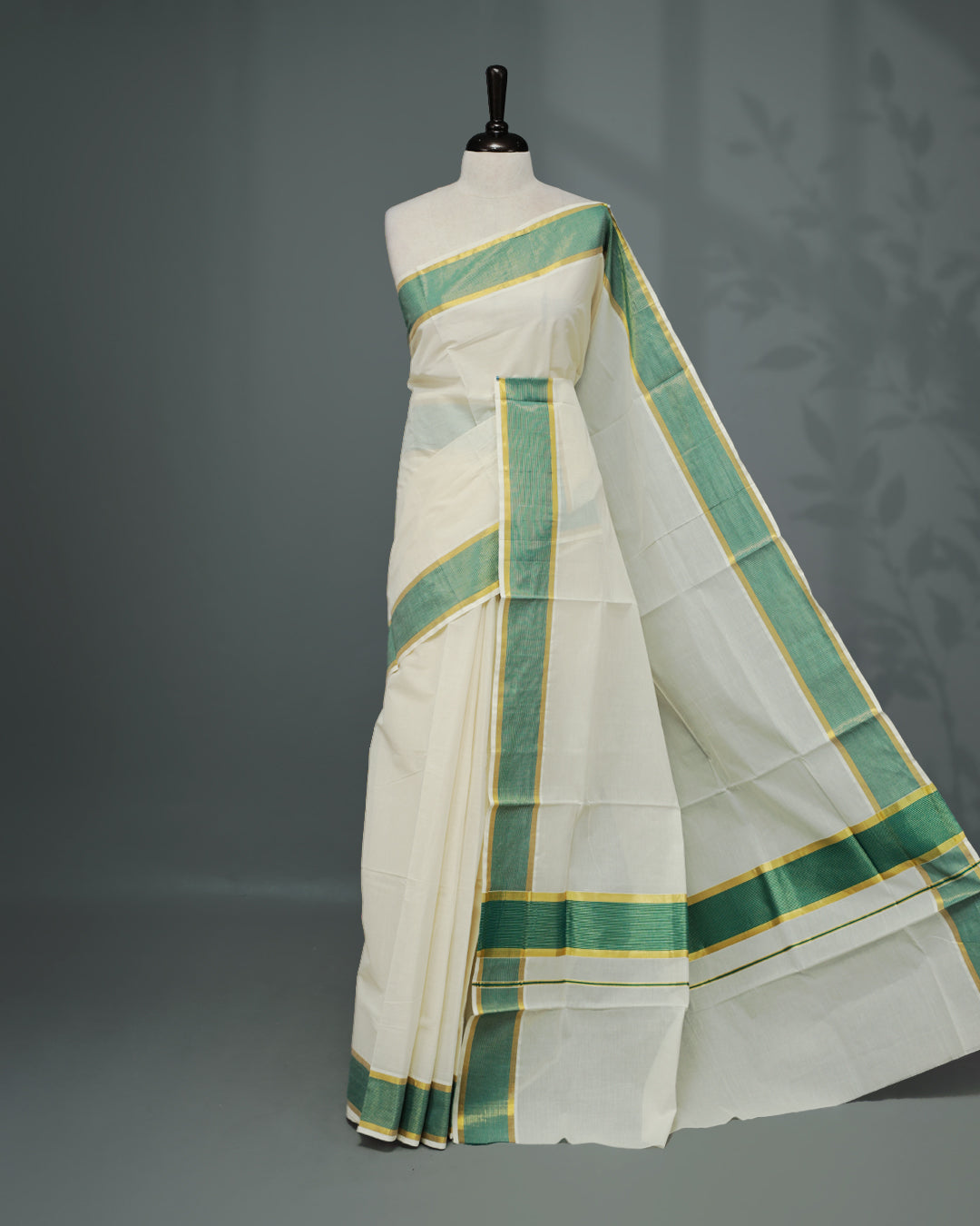 Cream colour Kerala saree Featuring an Elegant plain body, complemented by a classic gold & Green zari border, matching blouse piece.