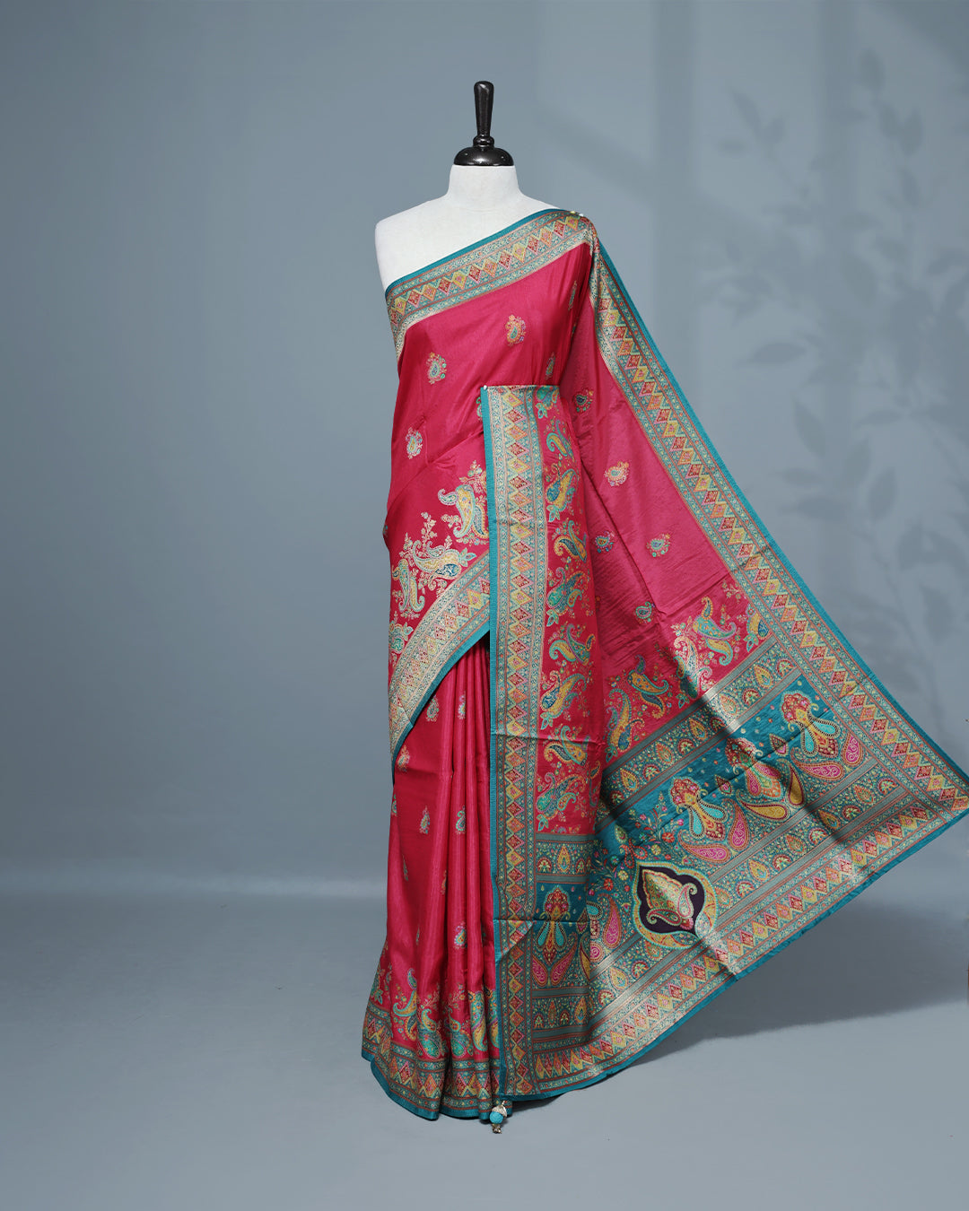 Rani Pink Colour Pashmina Saree featuring Mango motifs on body, complemented by Contrast Teal colour with Floral pattern & gold zari on border and Pallu, comes with matching blouse piece.