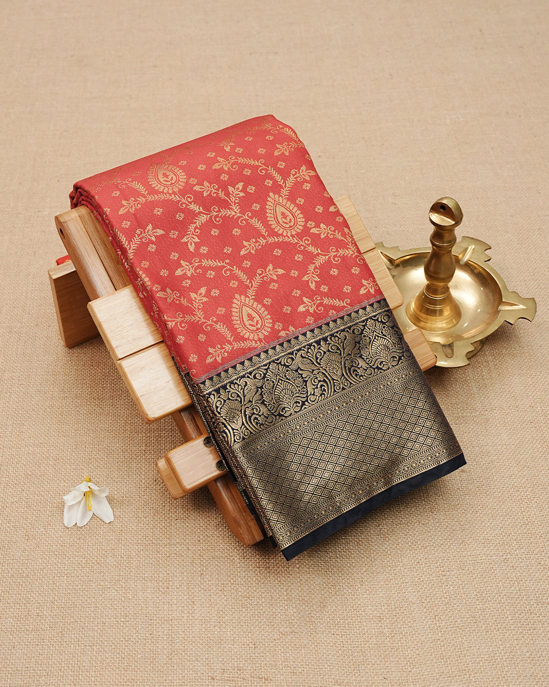 Dark Red colour semi wedding saree featuring gold zari Pattern on body, contrast navy blue colour with traditional border, paired with matching blouse piece.
