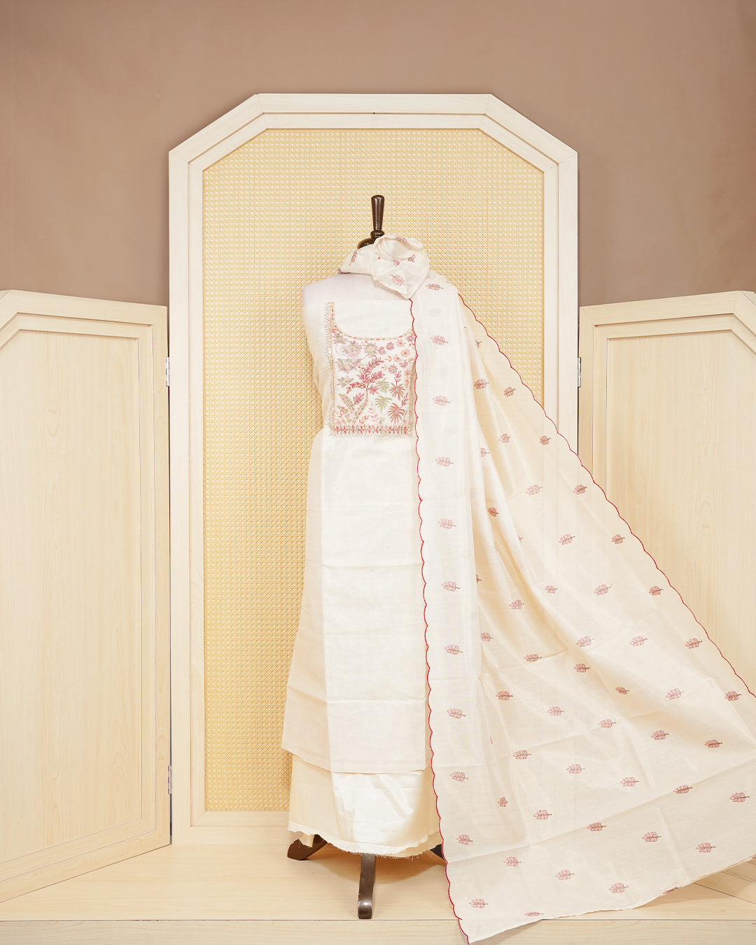 Cream tissue salwar material featuring elegant floral embroidery pattern adorned with beadwork, paired with matching bottom and elegant dupatta.