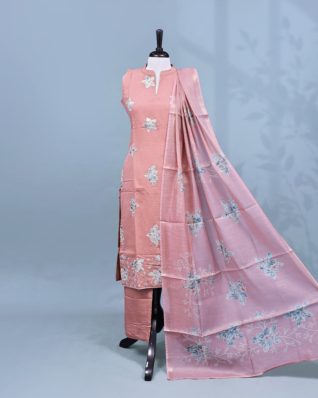 Pastel Peach colour Salwar set comes top with floral pattern on body, paired with matching bottom and dupatta.