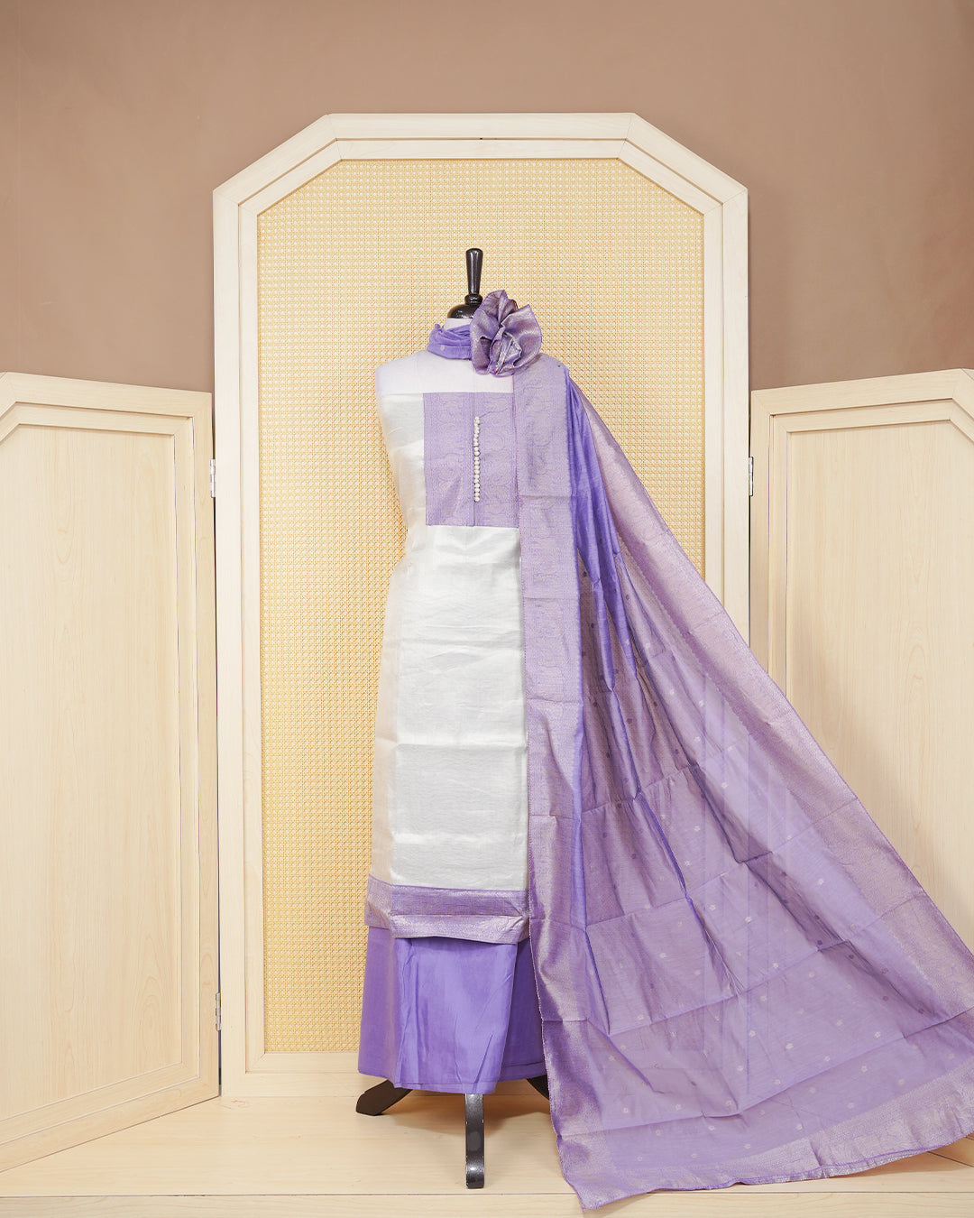 Cream colour Tissue salwar material featuring Plain Body Design without border, lavender colour work on neck portion, paired with matching bottom and elegant dupatta.
