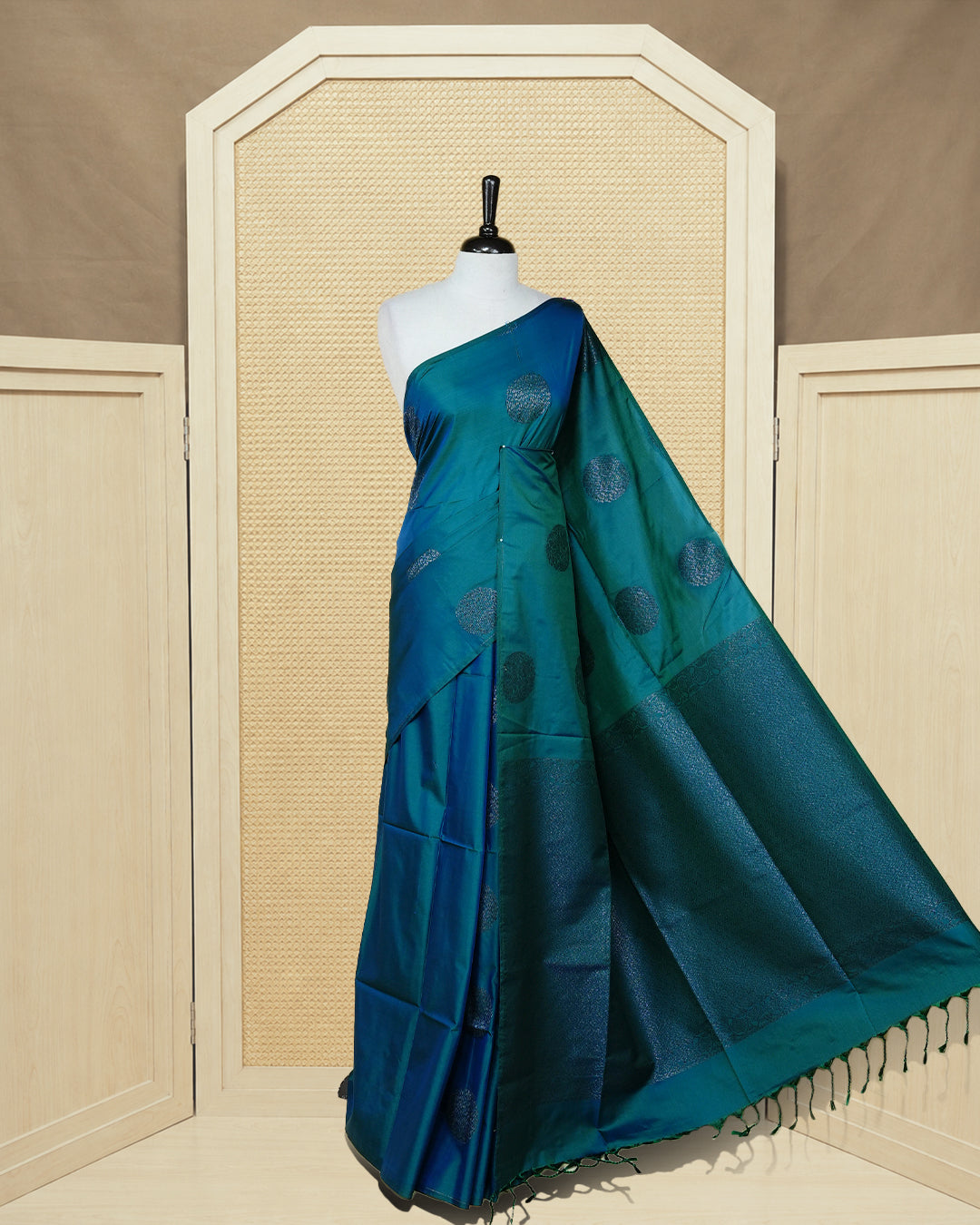 Peacock blue colour soft silk saree featuring antique zari motifs on body with contrast self colour pallu & paired with matching blouse piece.