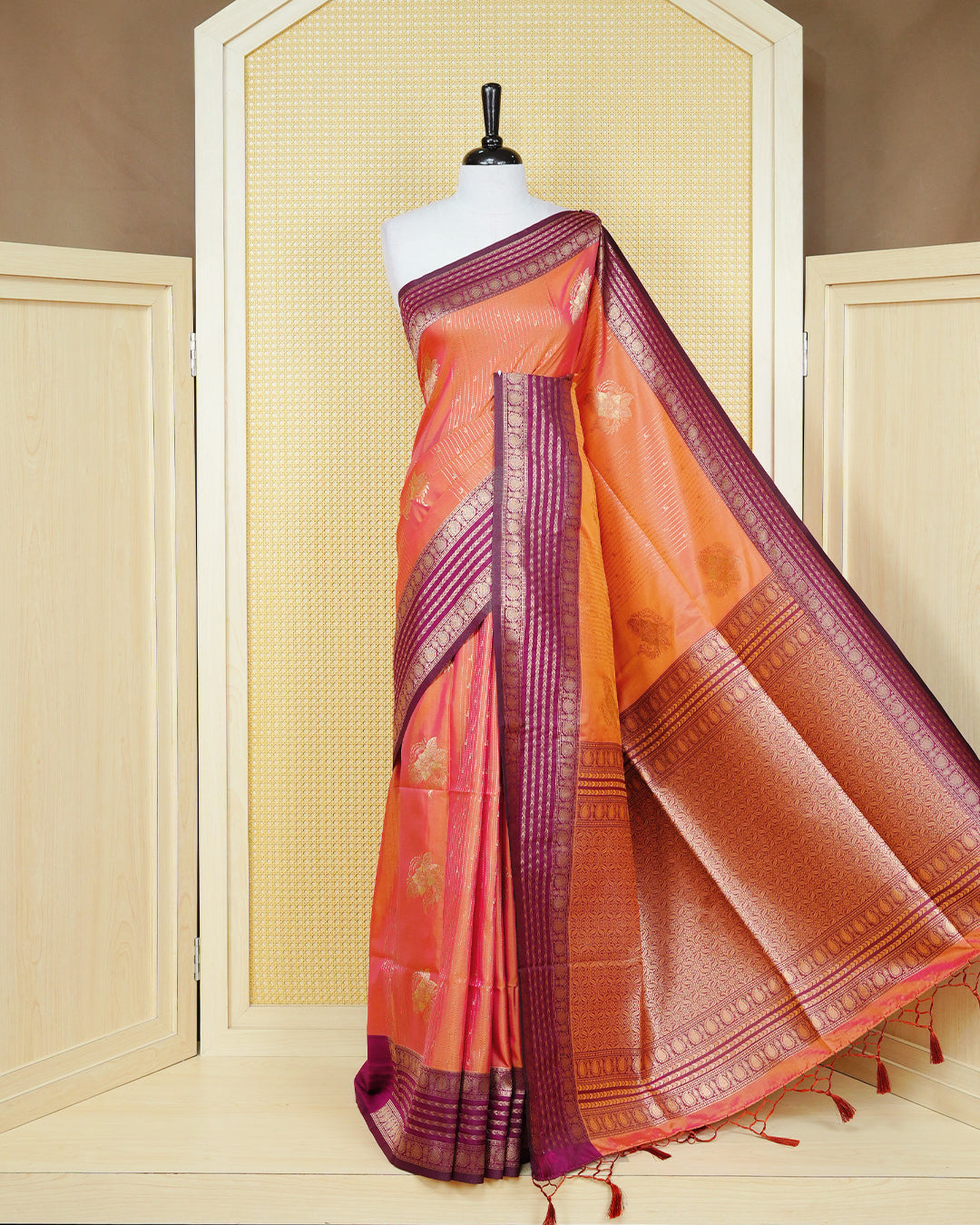 Rust orange & gold double shade Mulberry silk saree featuring floral gold zari patterns on body, paired with contrast purple colour with traditional border, comes with matching blouse piece.