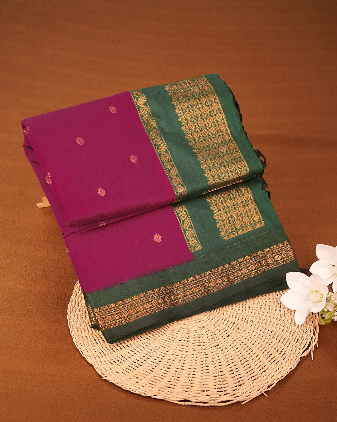Magenta colour kalyani cotton saree featuring gold zari Floral pattern on body, complemented by Green colour with Gold zari border, paired with matching blouse piece