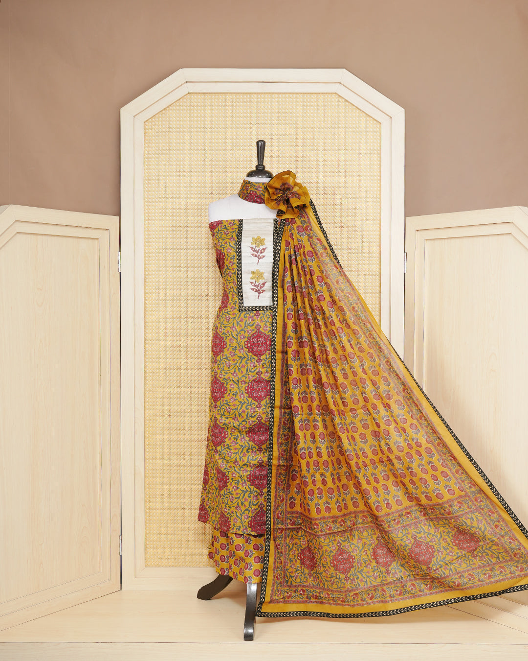 Dark yellow colour salwar material featuring Floral print and mirror work with elegant border, paired with matching bottom and an elegant dupatta.
