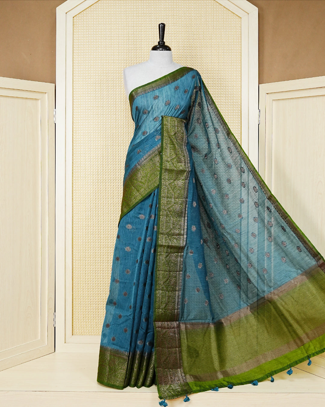 Teal blue colour semi linen saree thread motifs on body, contrast green colour gold zari border, rich pallu comes with matching blouse piece