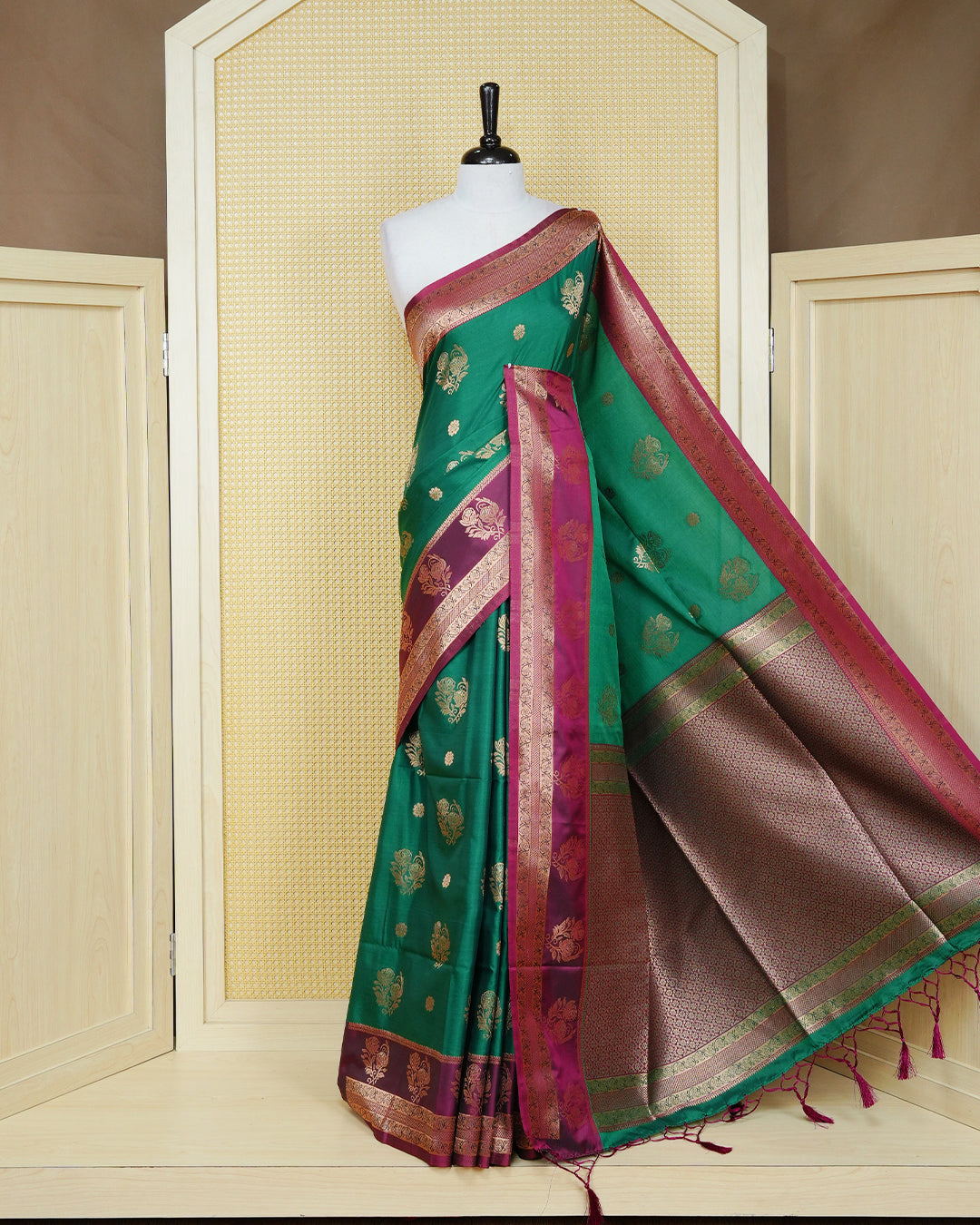 Green colour Mulberry silk saree featuring gold floral zari patterns on body, paired with contrast maroon colour with traditional border, comes with matching blouse piece.