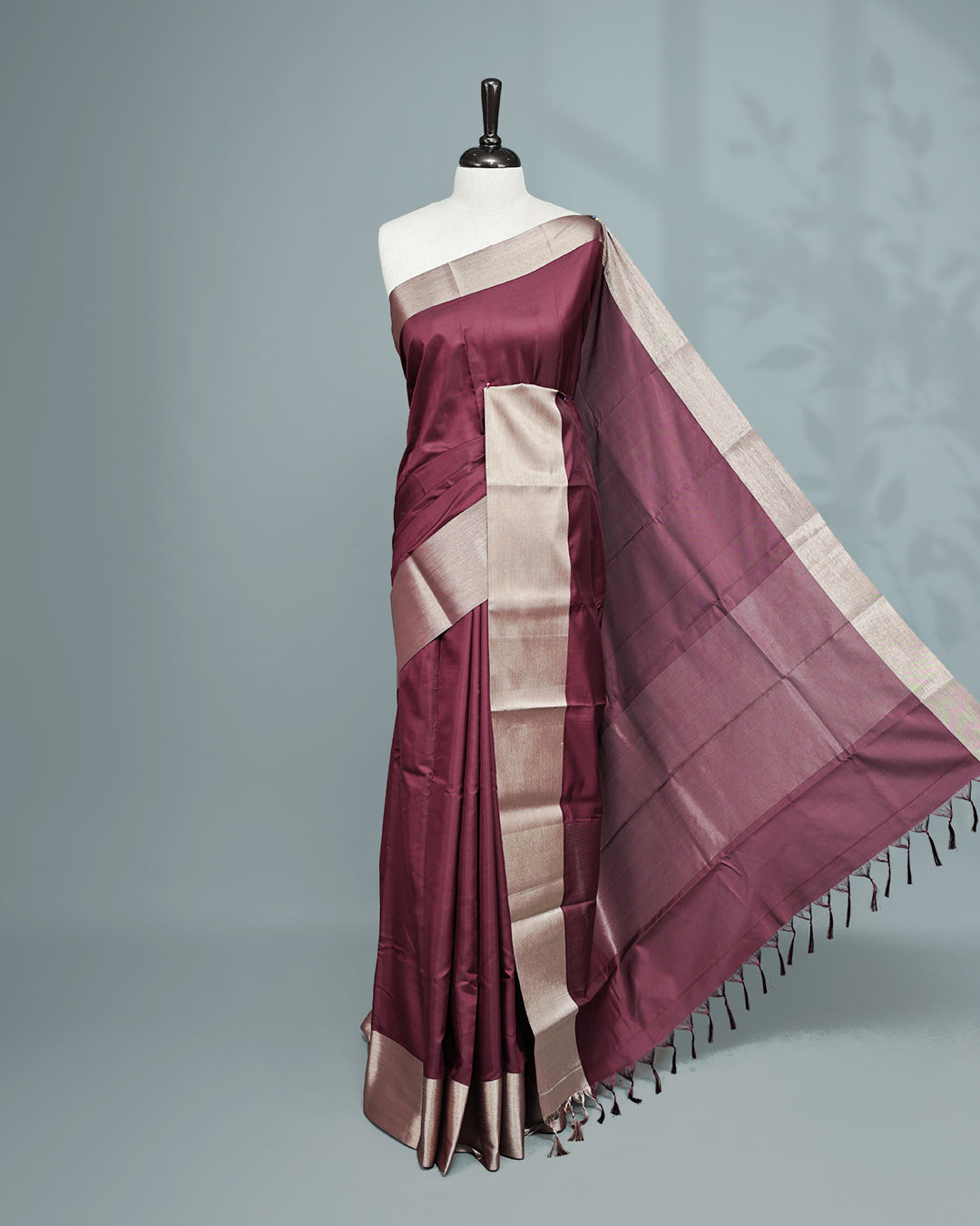 Wine colour saree featuring a plain body, complemented by a Bavanchi border and contrast pallu, paired with a matching blouse piece..