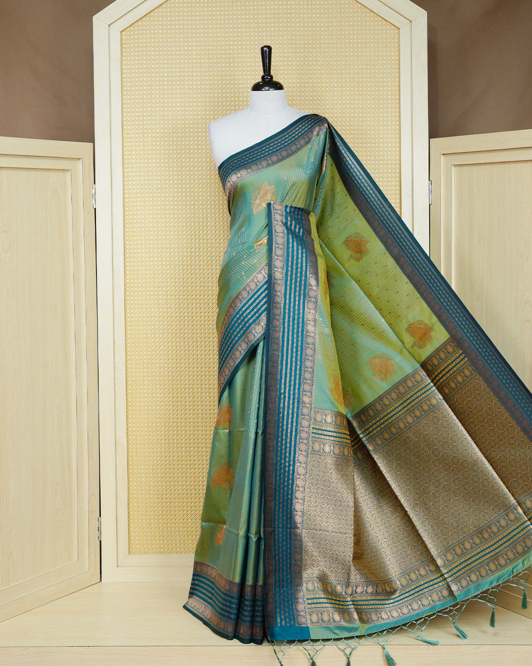Green & gold double shade Mulberry silk saree featuring gold floral zari patterns on body , paired with contrast bottle green colour with traditional border, comes with matching blouse piece.