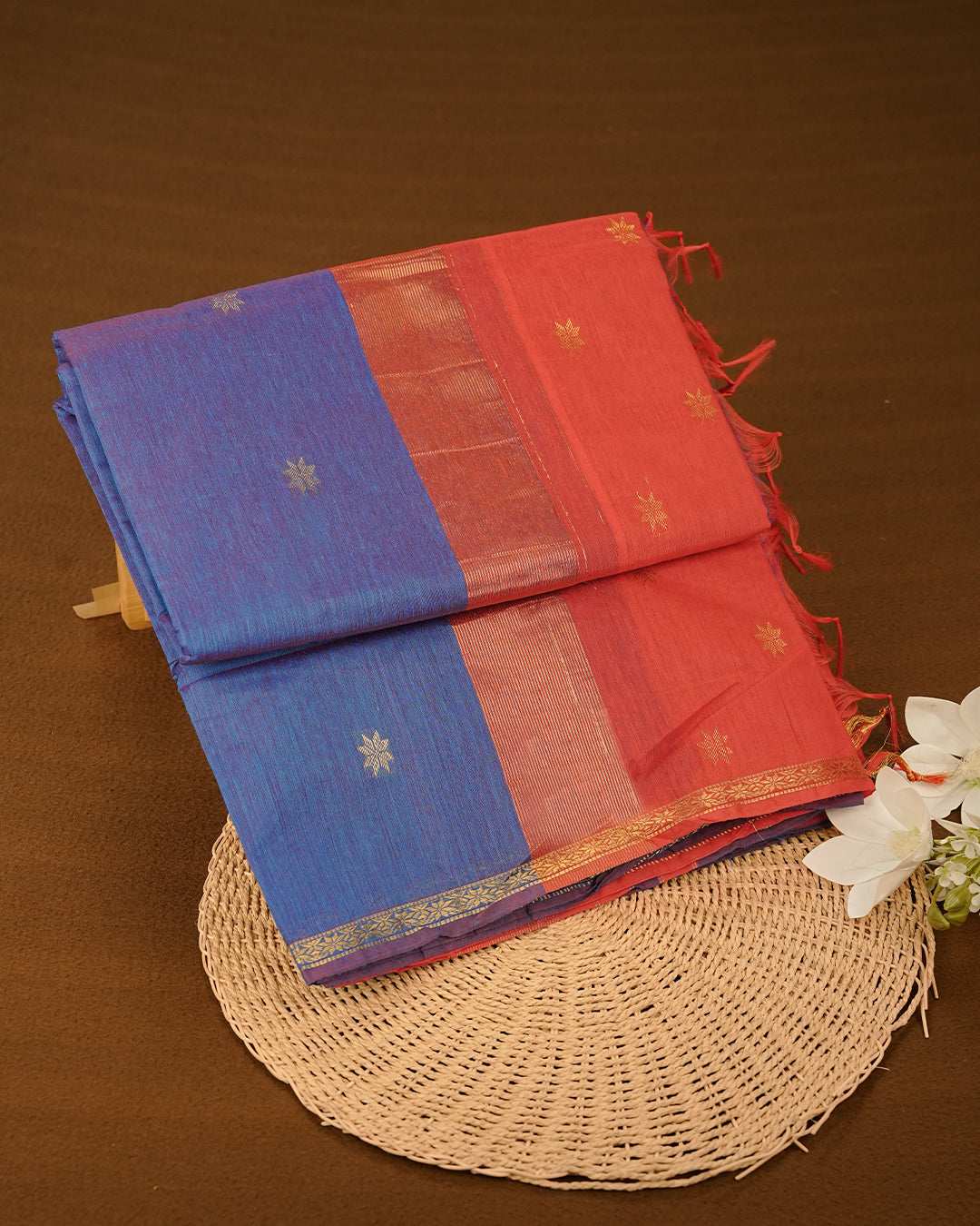 Blue & Red Dual colour kalyani cotton saree featuring gold zari Floral pattern on body, complemented by Red colour with Stripes & Floral Gold zari border, paired with matching blouse piece
