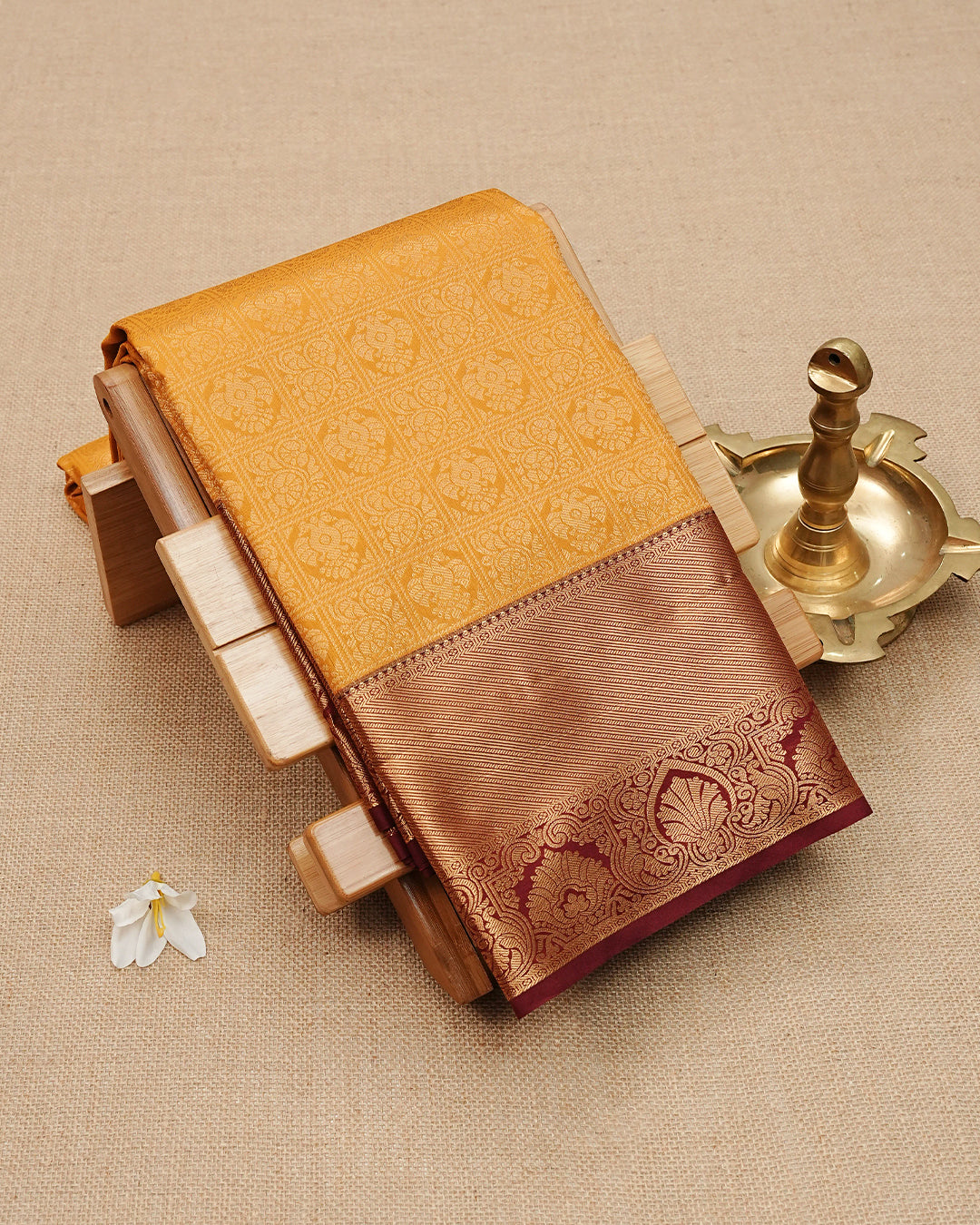Mustard Orange colour semi wedding saree featuring gold zari Peacock On Checks Pattern on body, contrast maroon colour with traditional border, paired with matching blouse piece.