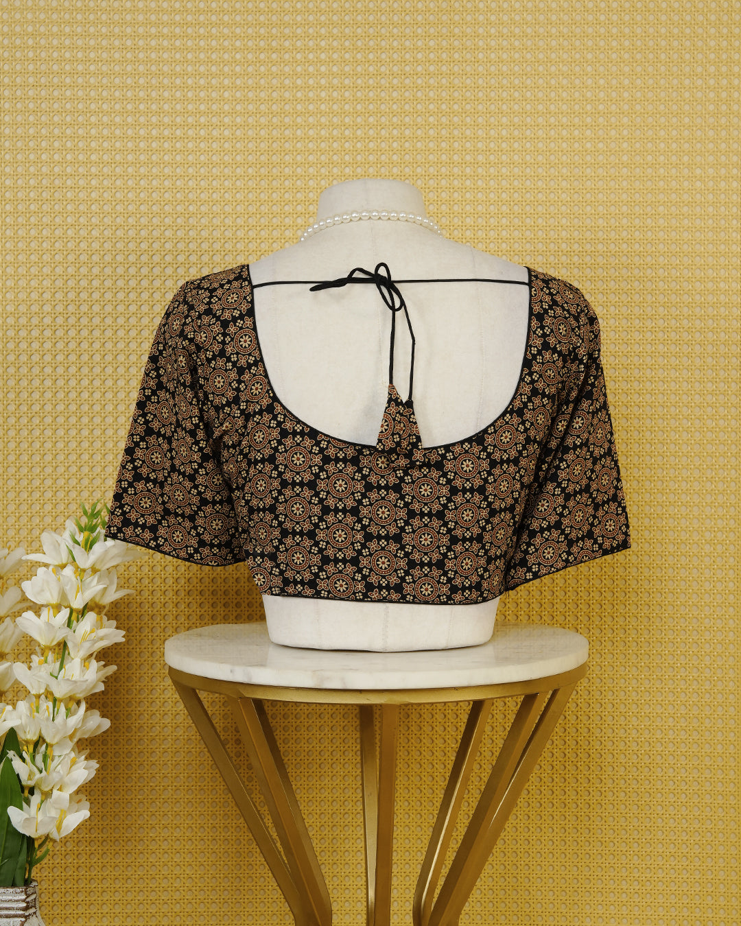 Black Colour Blouse Featuring A Classic U-Neck, Intricate Floral Geometric Print, And Comfortable Elbow Length Sleeves.