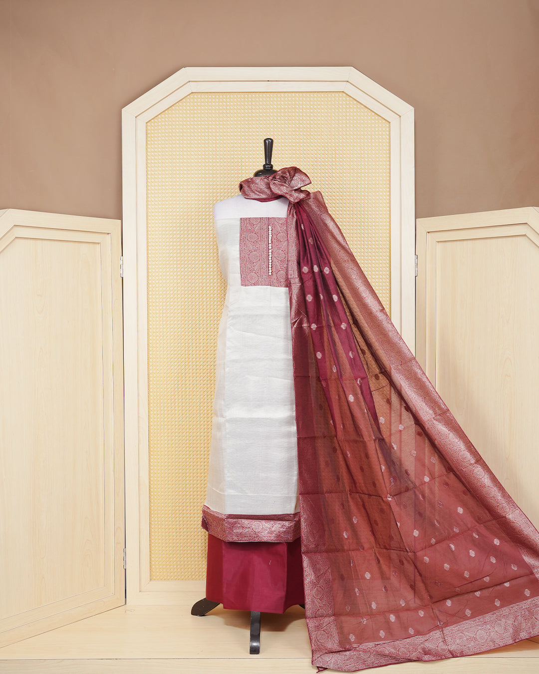 Cream colour salwar material featuring Plain Body Design without border, Maroon colour work on neck portion, paired with matching bottom and elegant dupatta.